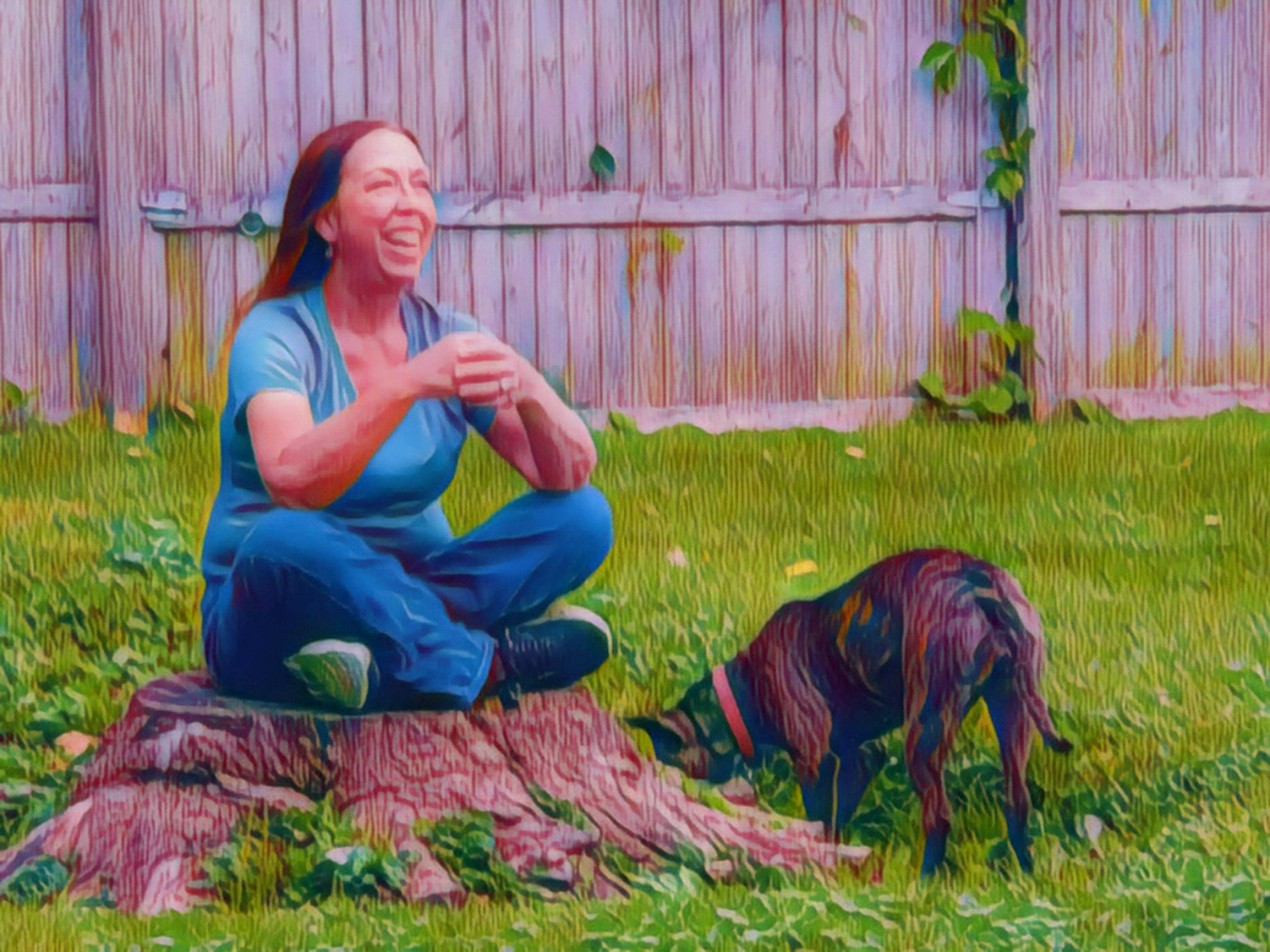 Sheboygan Dog Trainer sitting on a tree stump with dog close