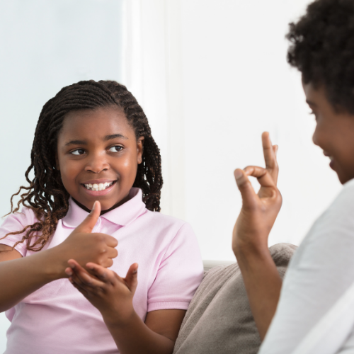 child and adult use sign language