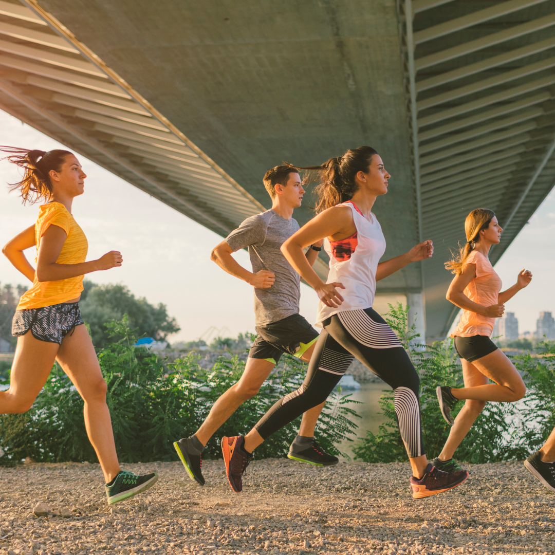 Athletes running under a bridge with optimised running practice routine. Such exercises are important to prevent ACL and calf injuries.