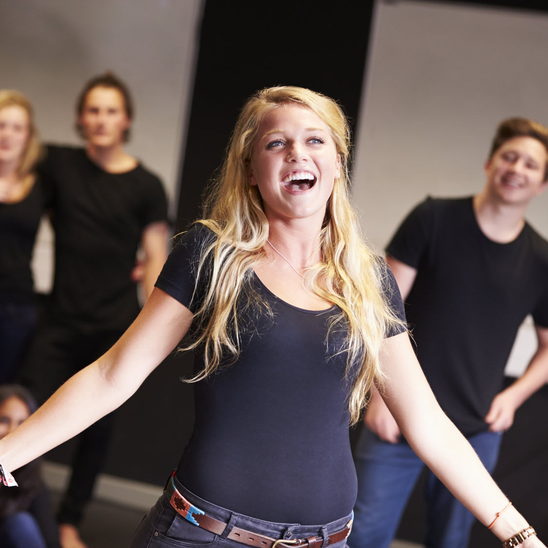 Young female musical theatre singer singing in a group class