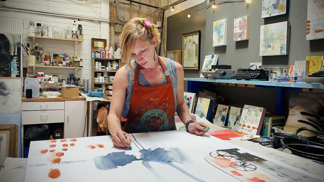 Dana printing a fine art lithograph with the printmaking press