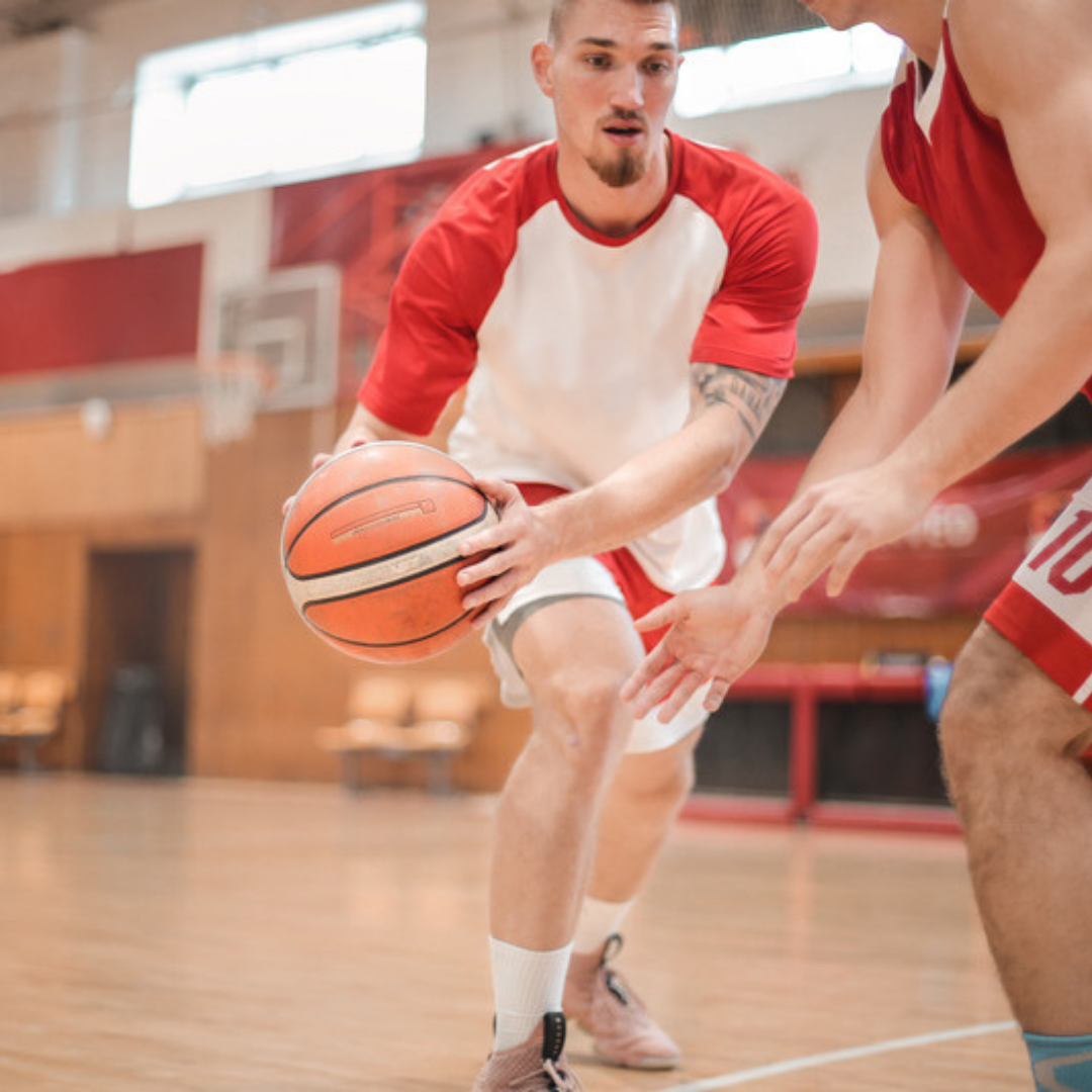 basketball player moves ball pass opponent using hamstring strength