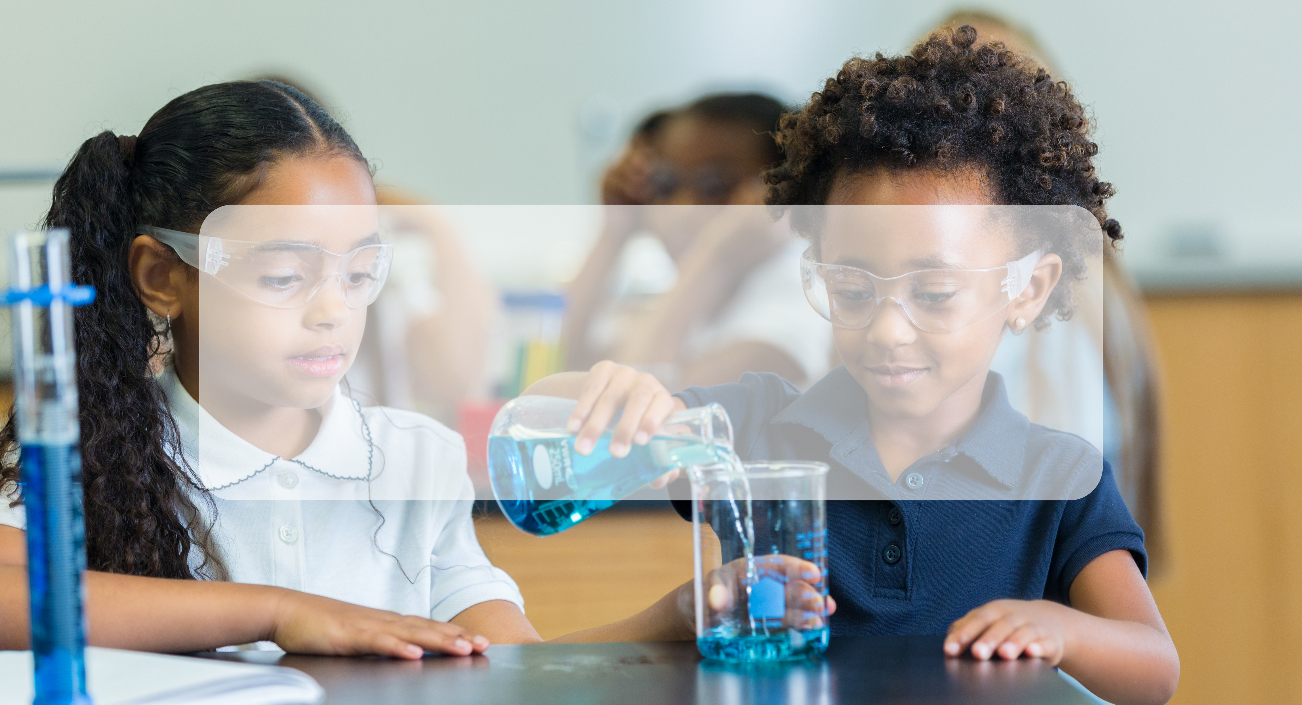 two students working with beakers in science class