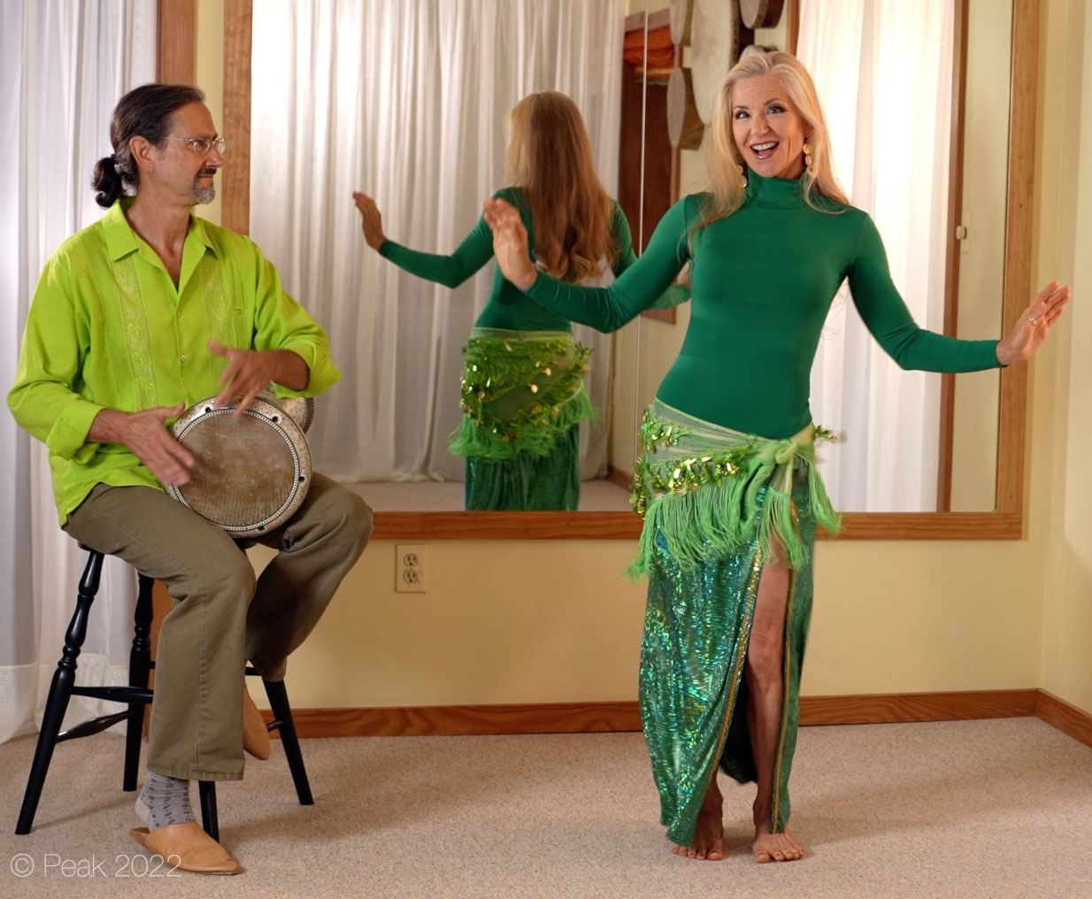 Jensuya and Bob smiling and drumming and belly dancing in studio