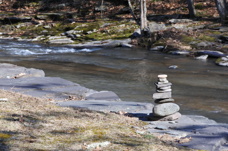 Stones balanced atop one another near a river