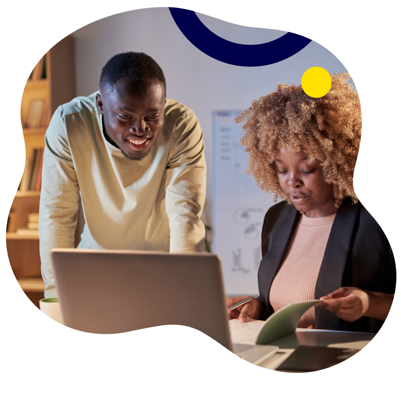 Man and woman looking at computer and other materials together