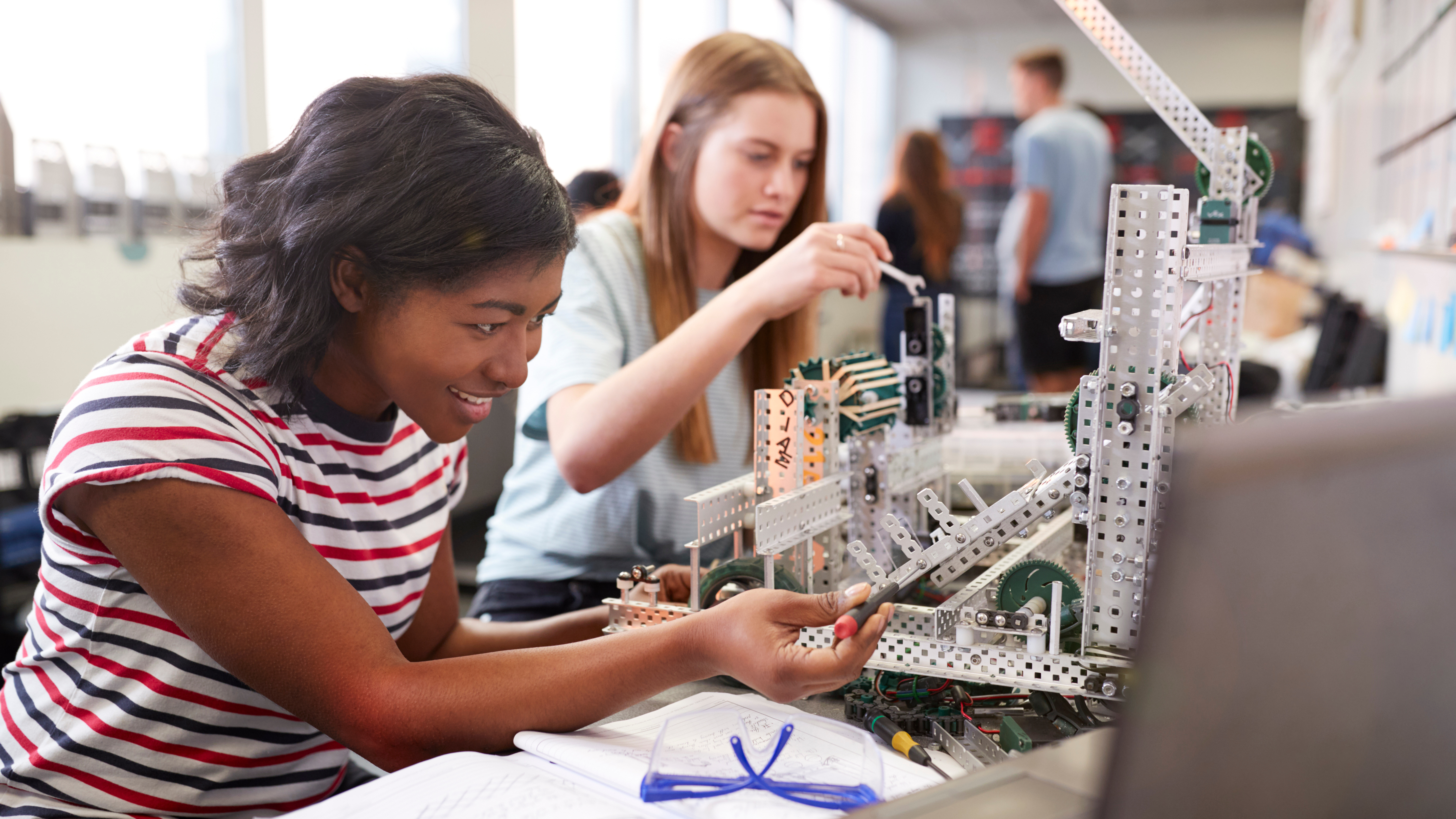 female students building with engineering tools