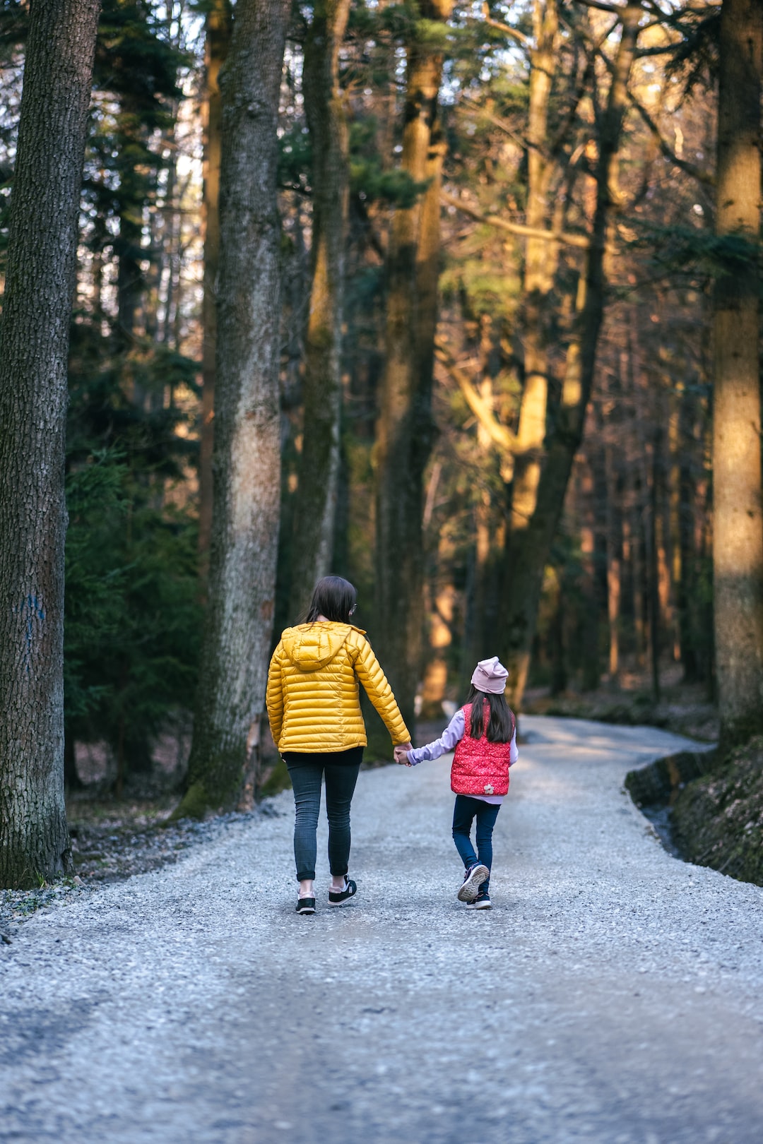 mom and girl walking in woods