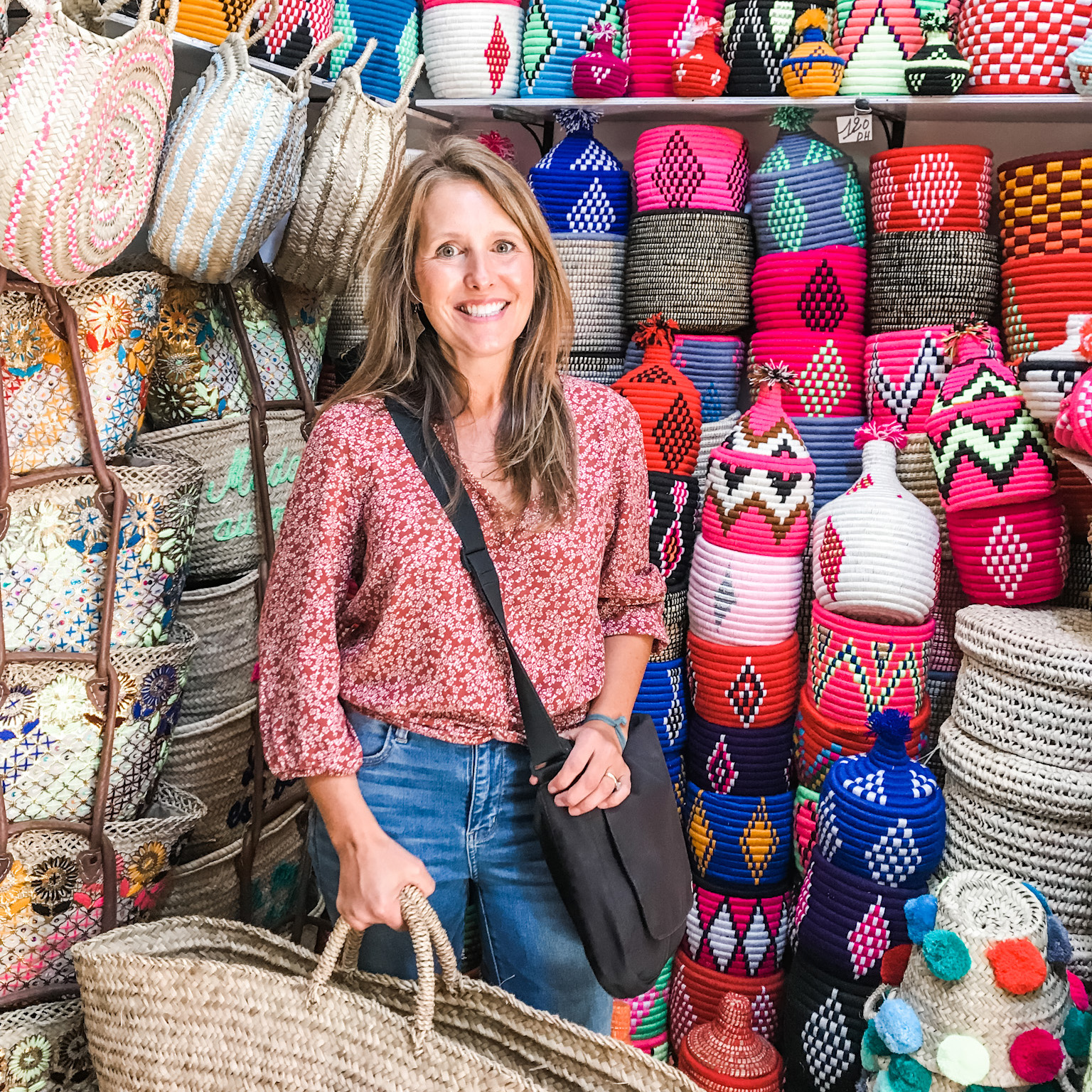 Photo of Stacey Edgar holding a basket in an artisan shop