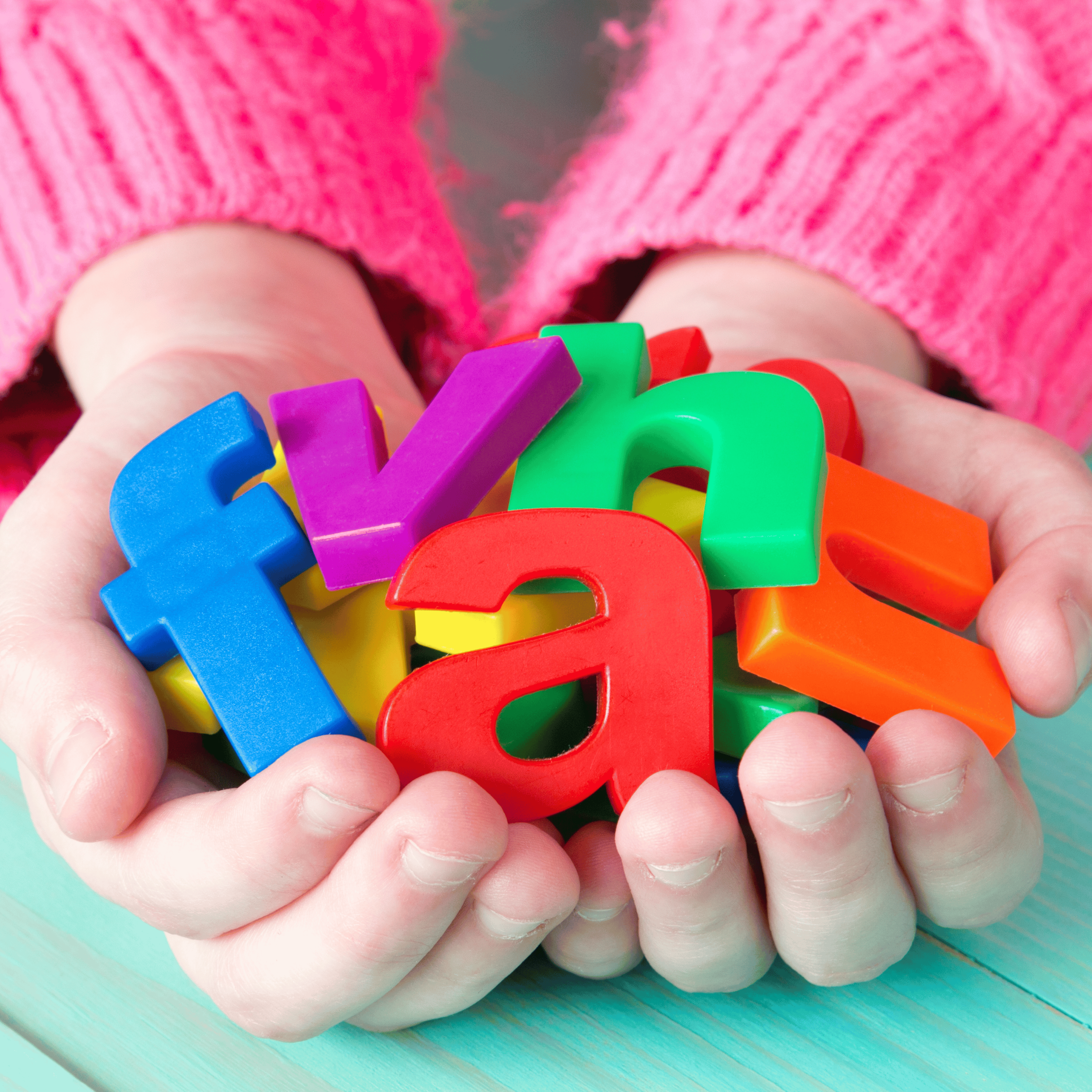 child holding magnet letters