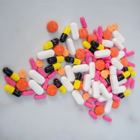 A bunch of opioid pills on a table.