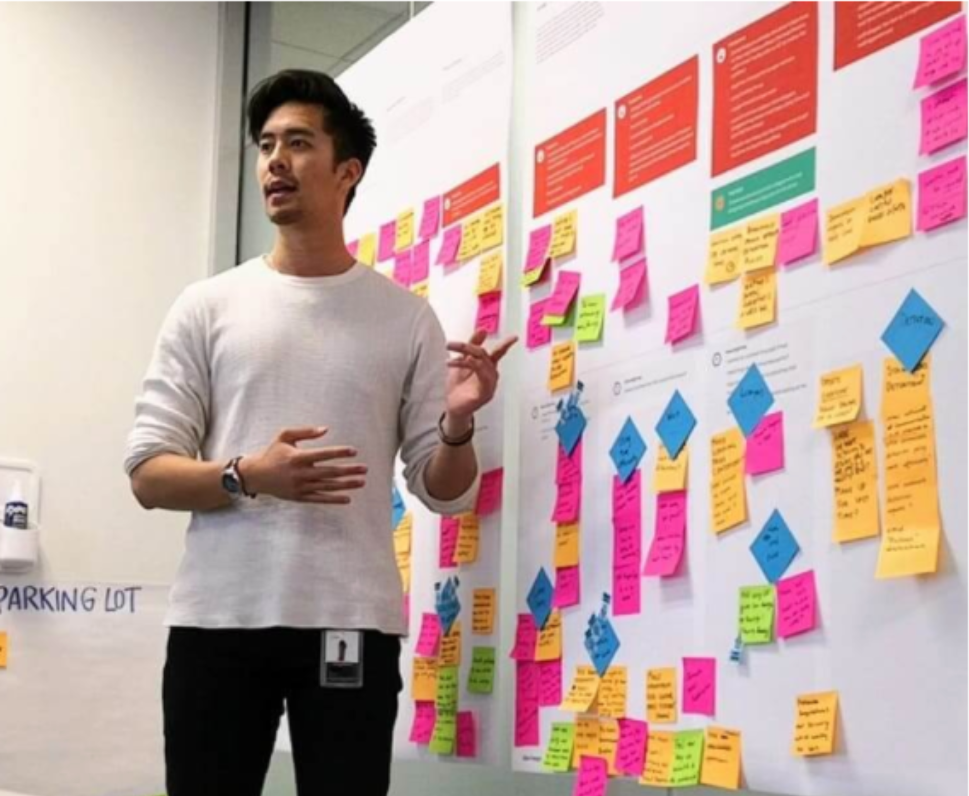 me speaking in front of a user journey map with lots of sticky notes