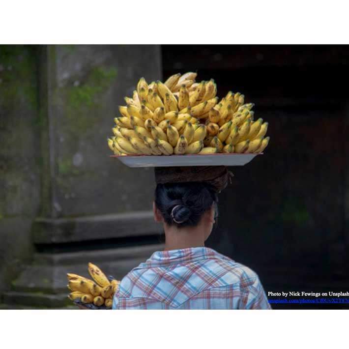 Woman Walking with Bananas On Her Head