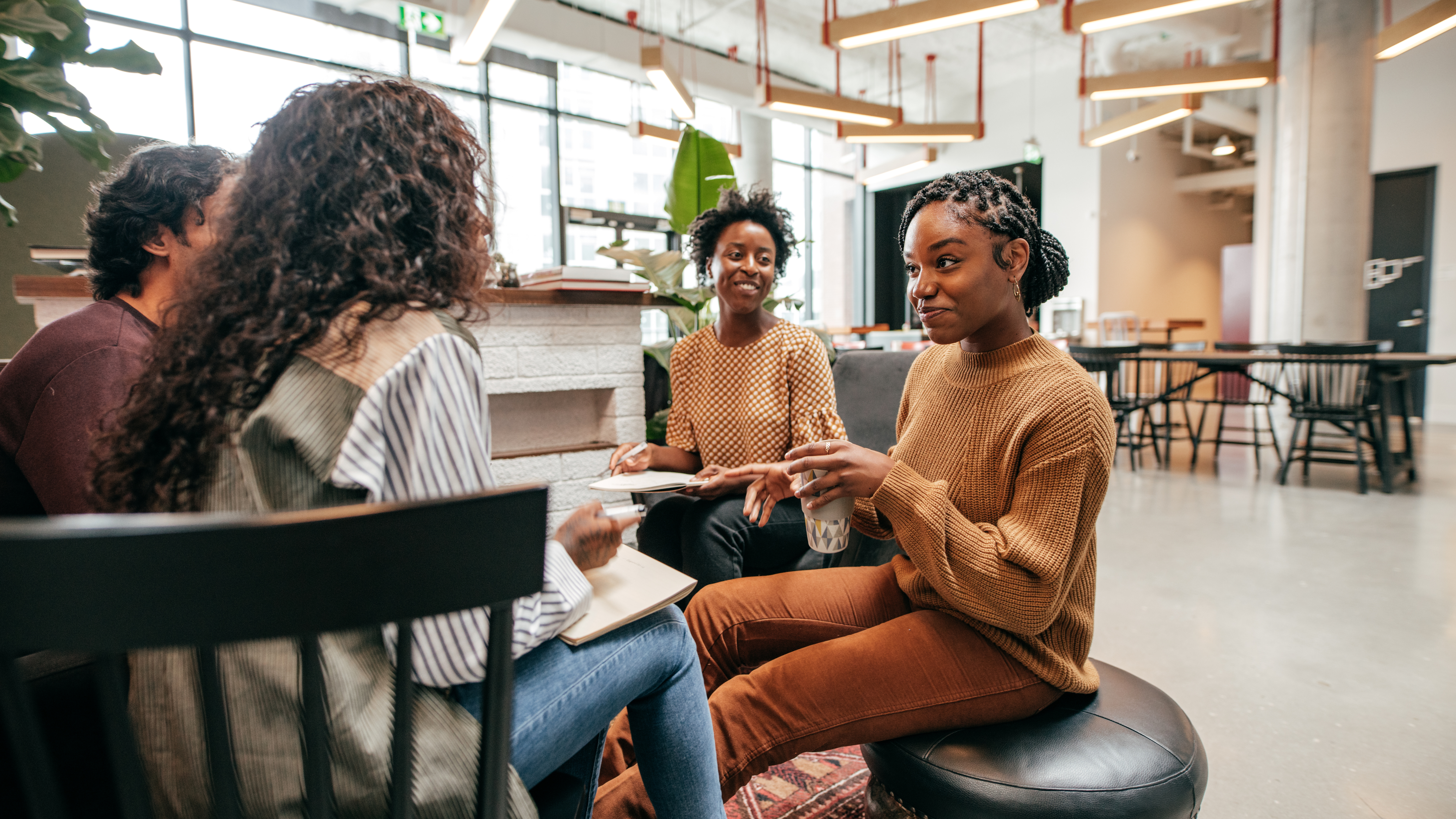 four people having a conversation in a community center