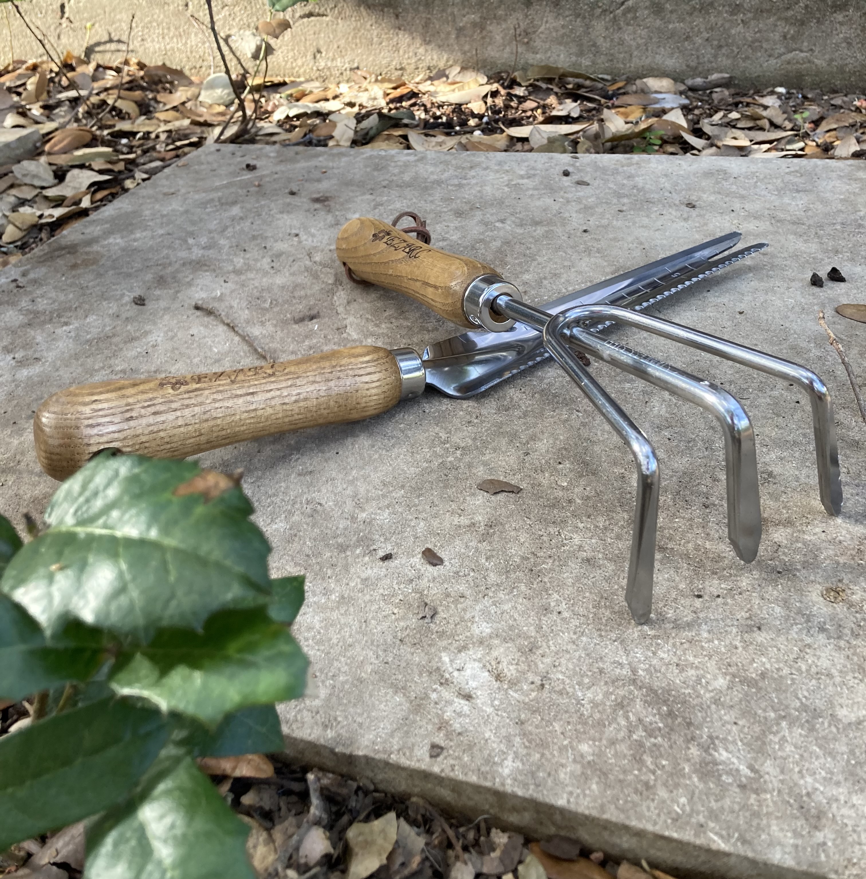 Hand garden tools crossed on pavement