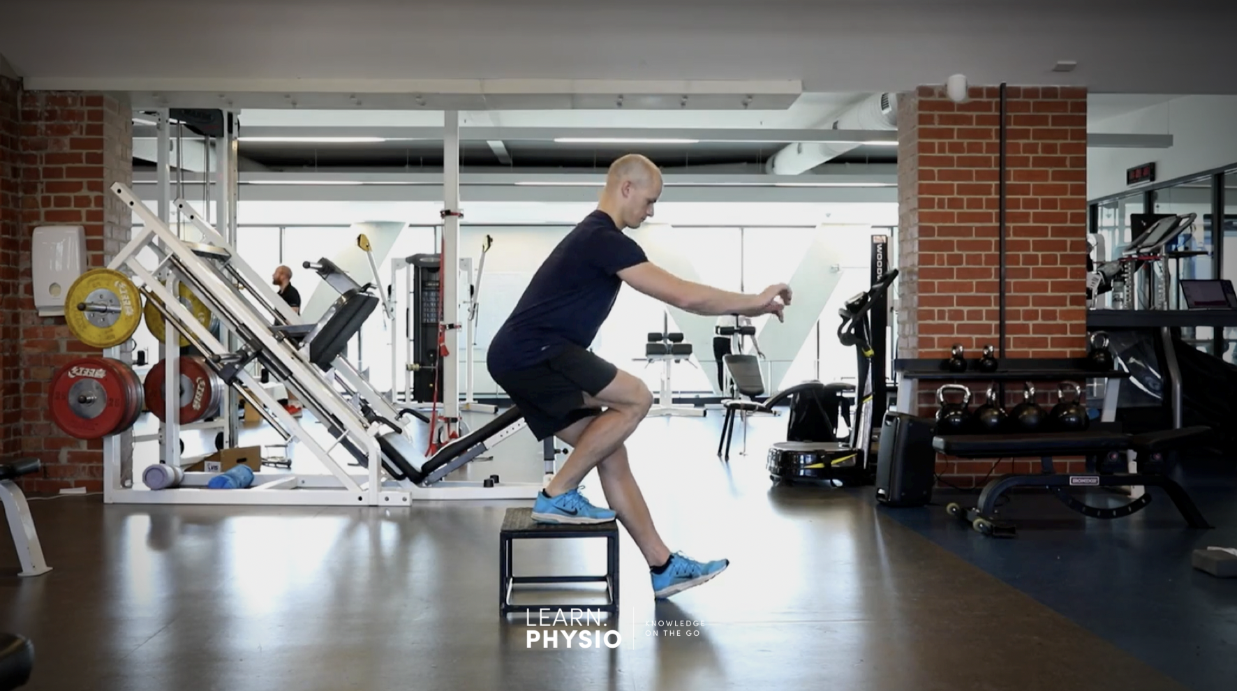 Man performing ACL rehabilitation exercises on a balance stool after ACL reconstruction surgery to get back to playing sports.