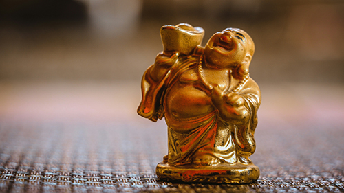 A statue of a laughing monk