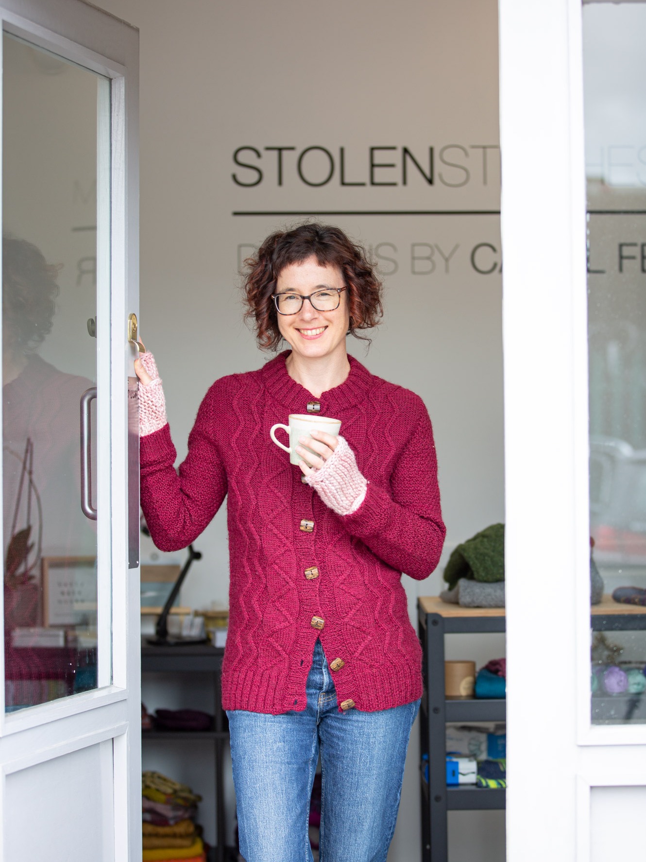 Carol Ferller stading in doorway of studio