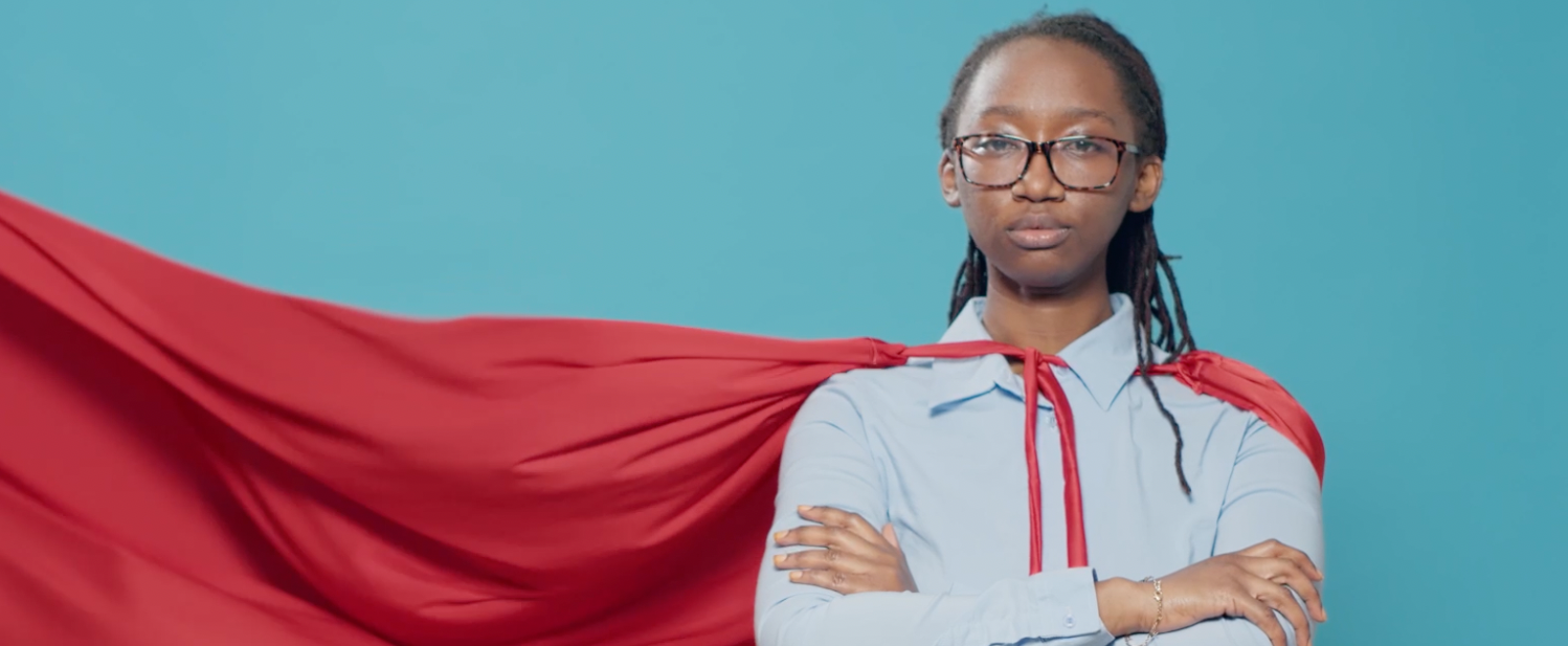 Strong black teenage girl in red cape