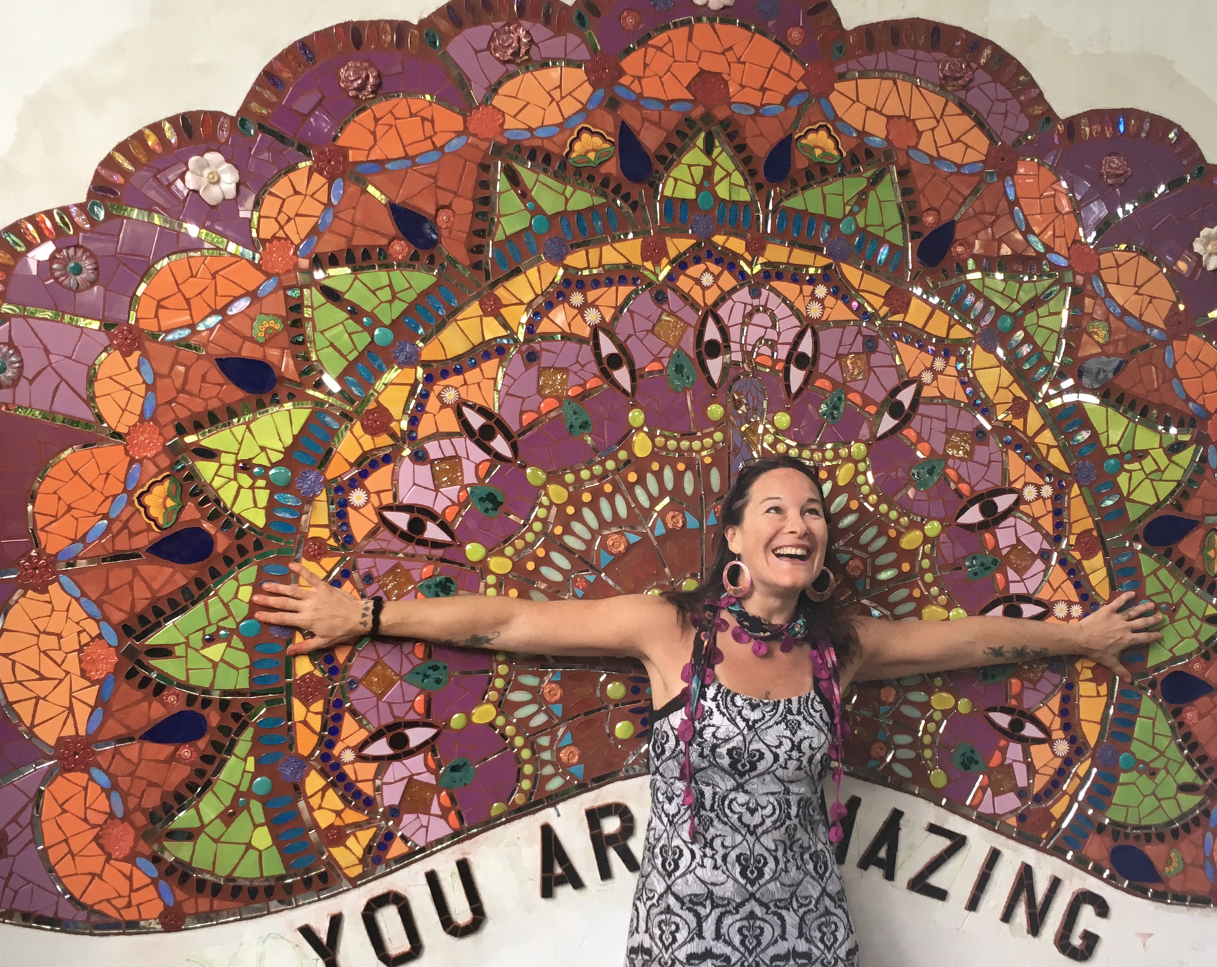 Laurel True in front of &quot;You are Amazing&quot; mosaic mural