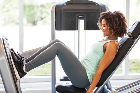 Woman doing leg press to strengthen quad muscles and continue with ACL rehabilitation. 