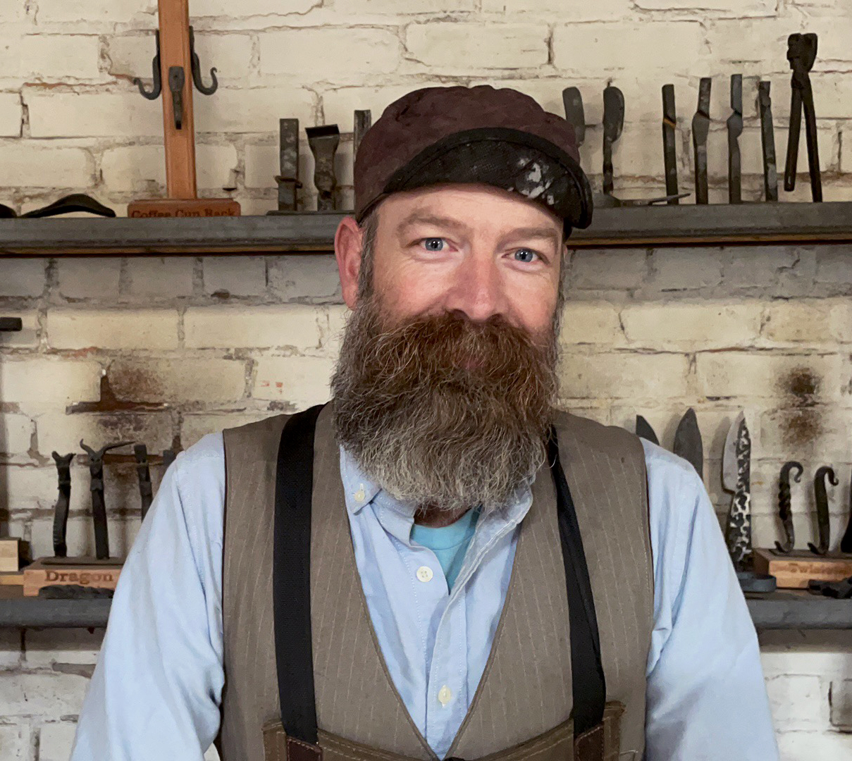 Yori Seeger in front of the blacksmithing shop