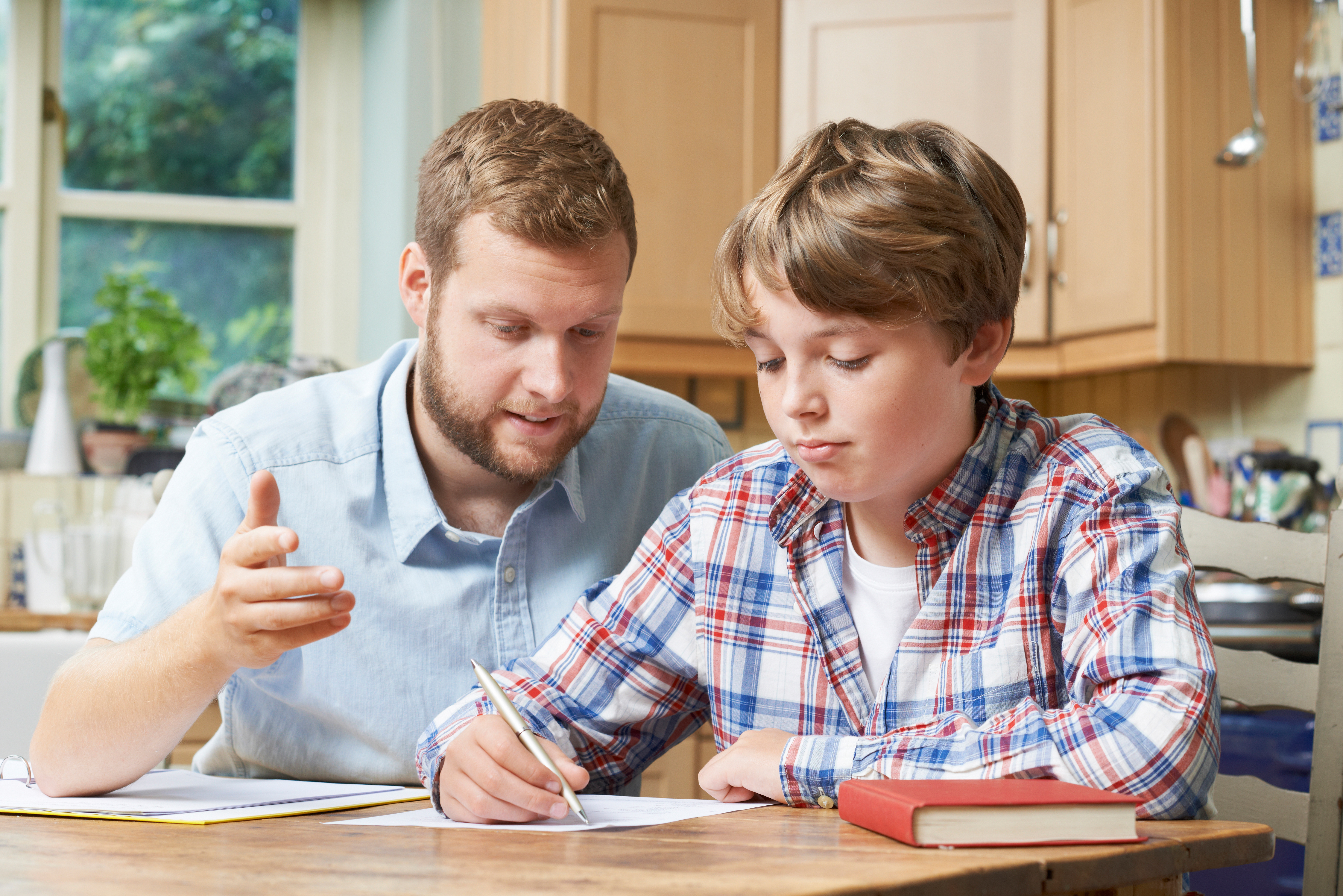 dad teaching son dad tutoring son homeschooling