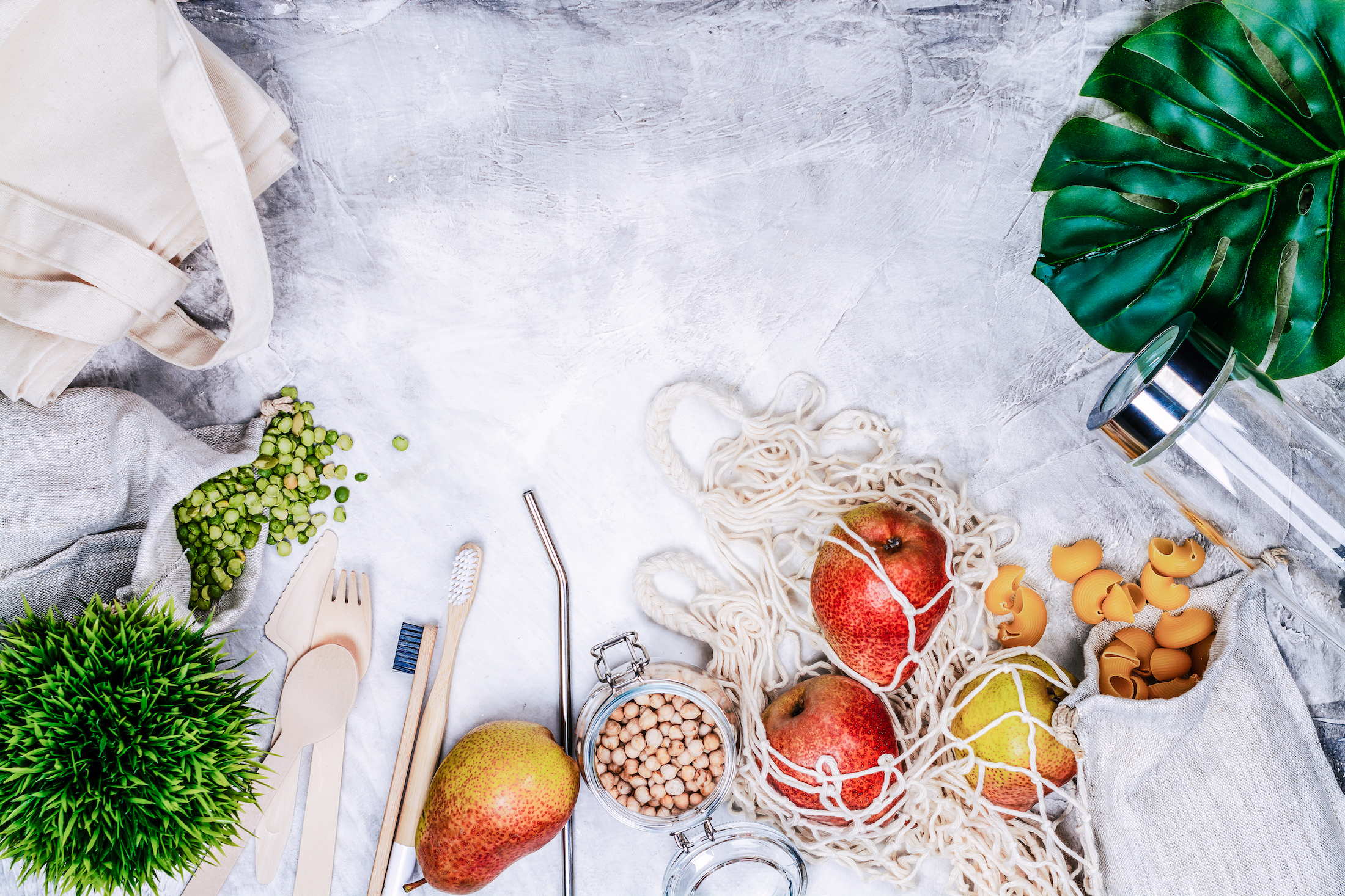 dried beans, fruit, and eco-friendly kitchen tools on a blue table