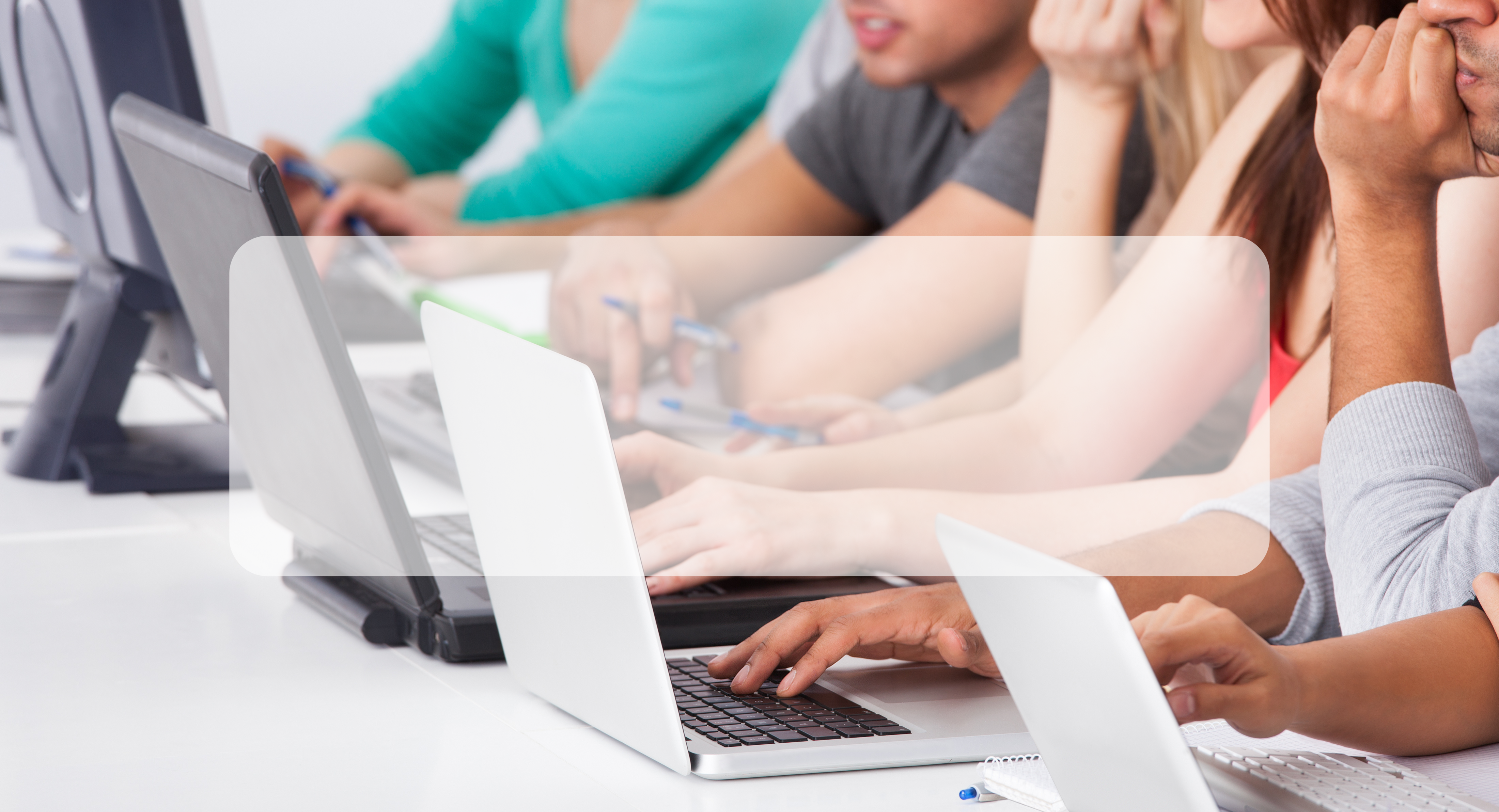 students working at laptops with hands on keyboards