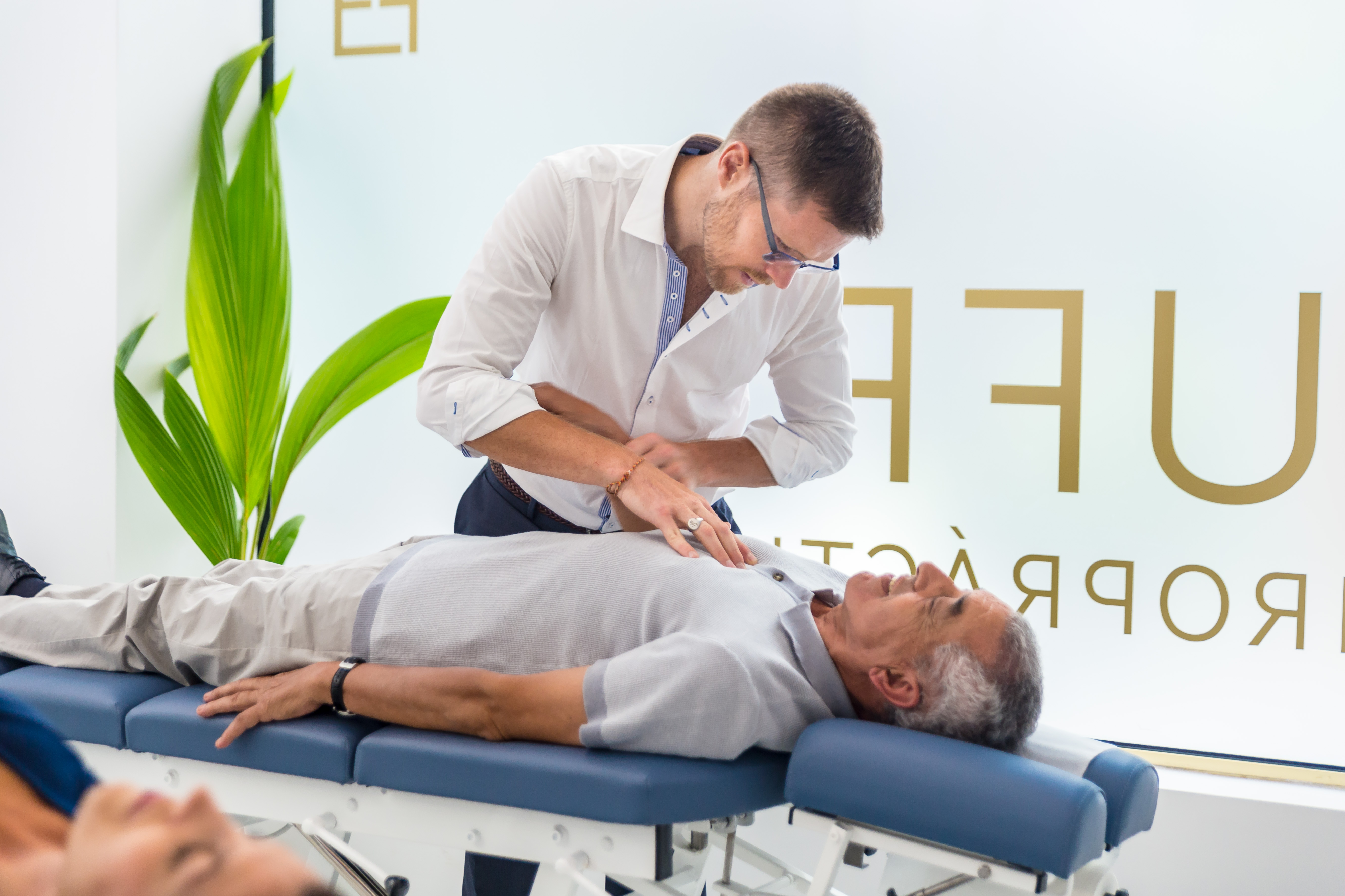 treating patient man chiropractic care