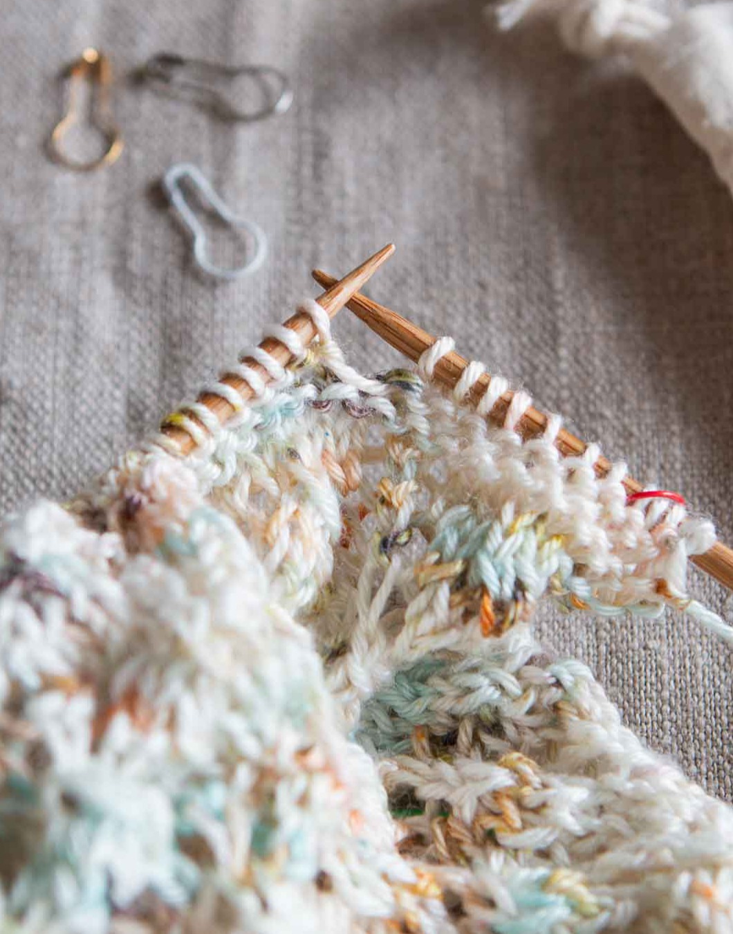 Close up shot of a lace knitting project still on the knitting needles.