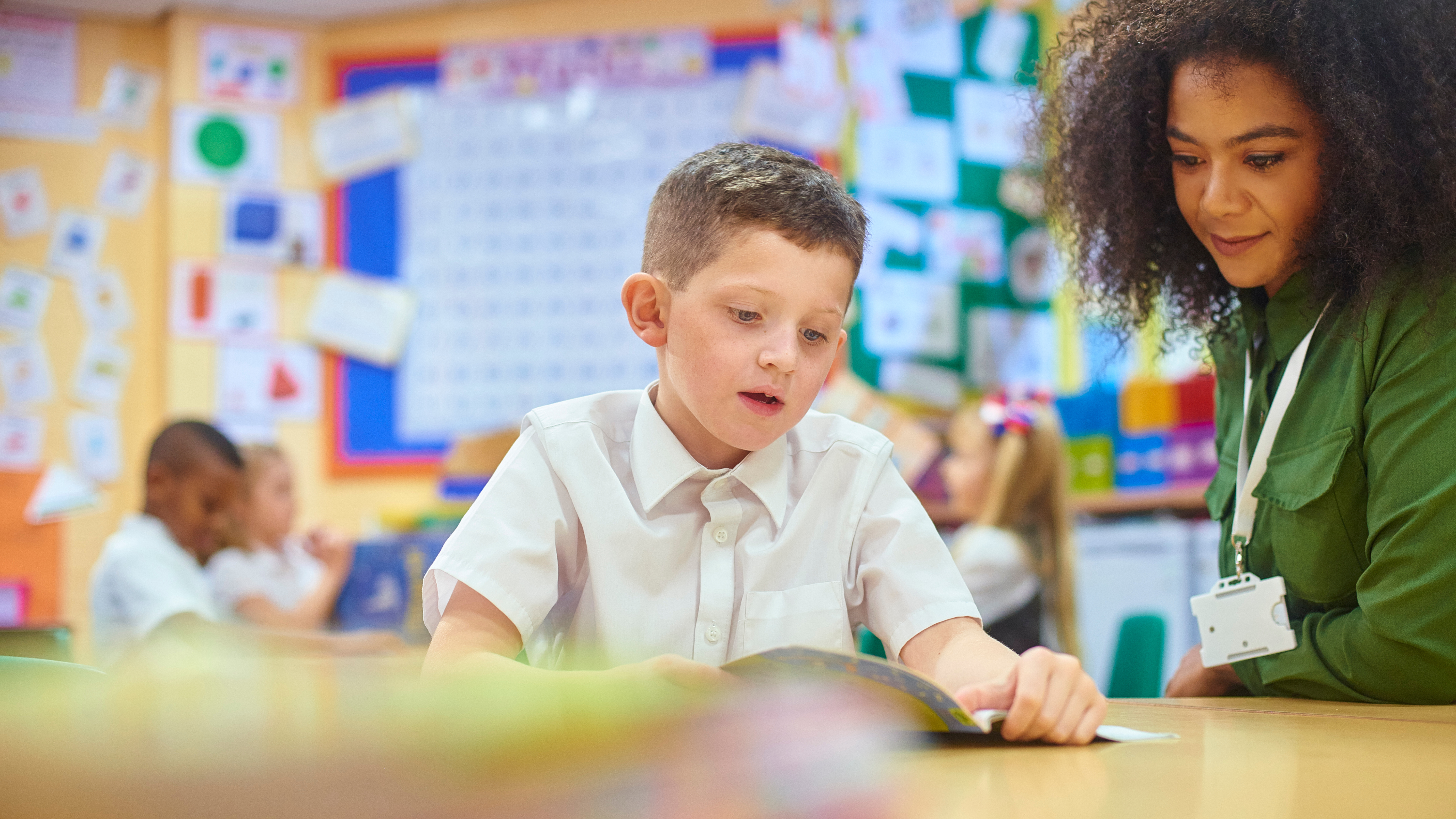 student reading to teacher