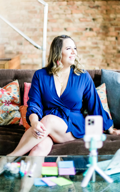 sarra cannon in blue on the couch, smiling