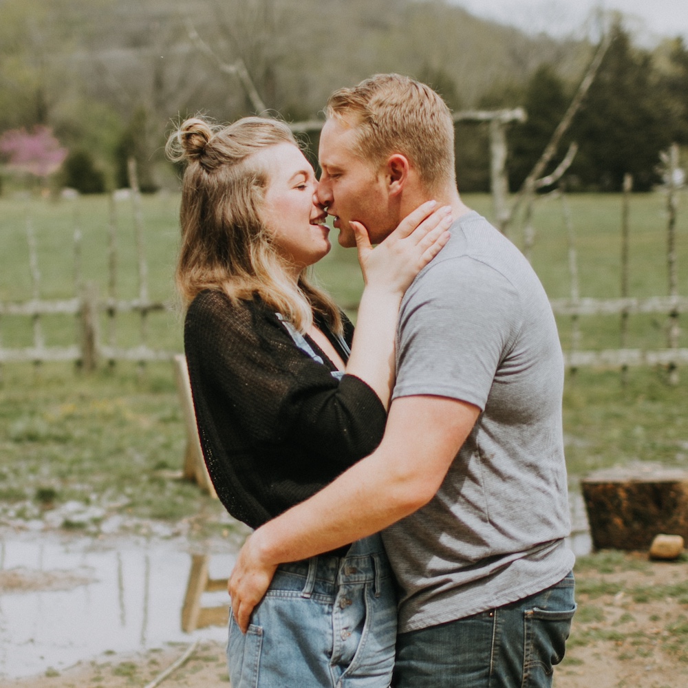 A young couple embrace in nature