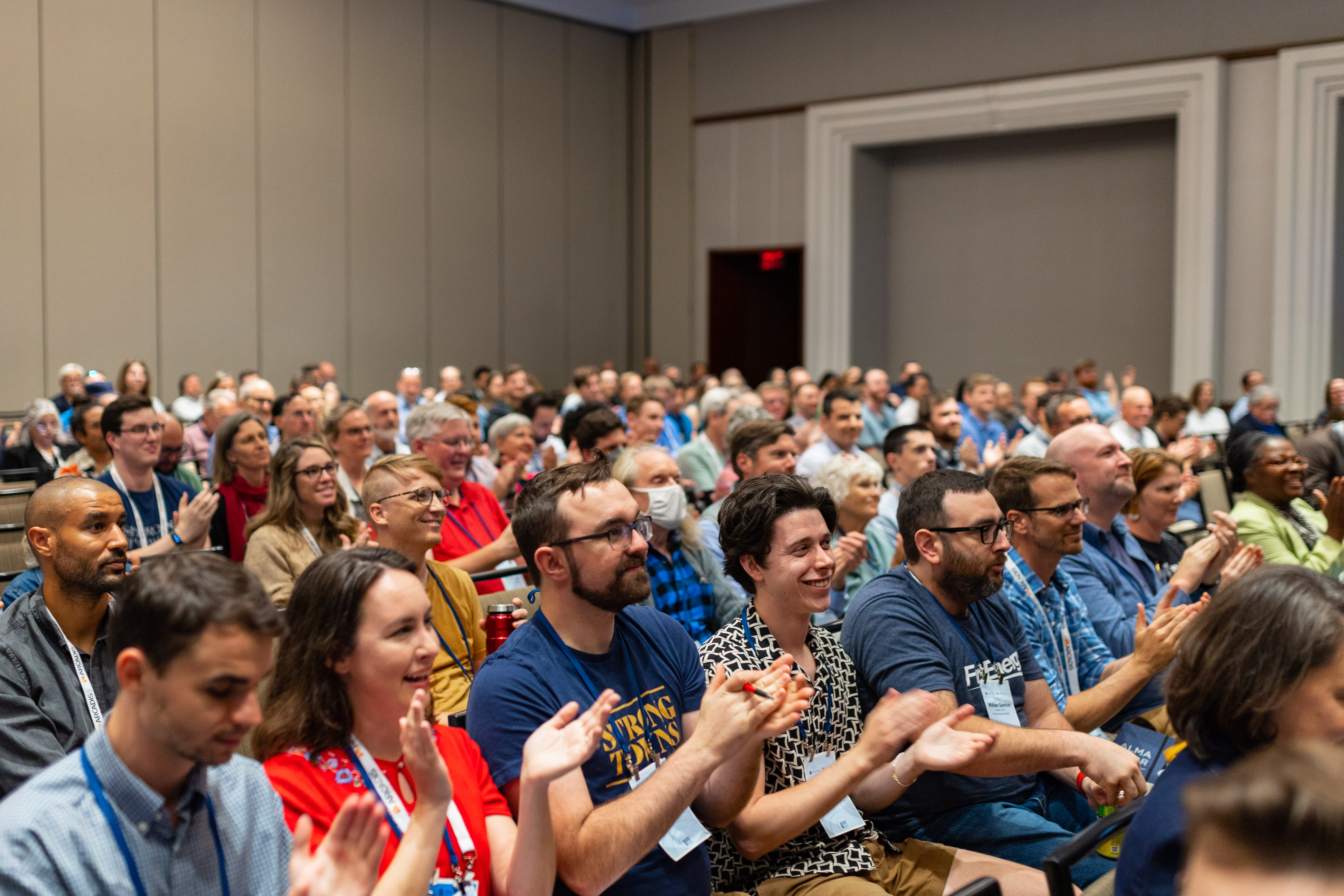 This image features Strong Towns members applauding during the National Gathering in Charlotte