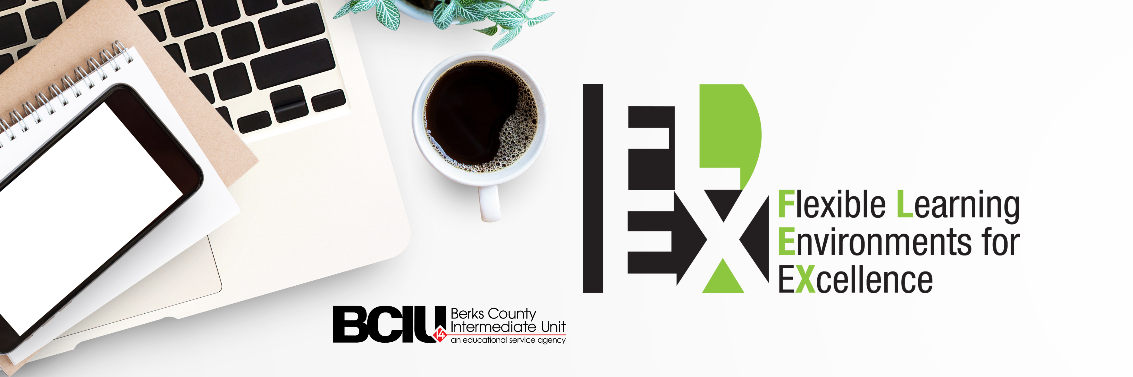 desktop with mug, laptop and notebooks with BCIU logo