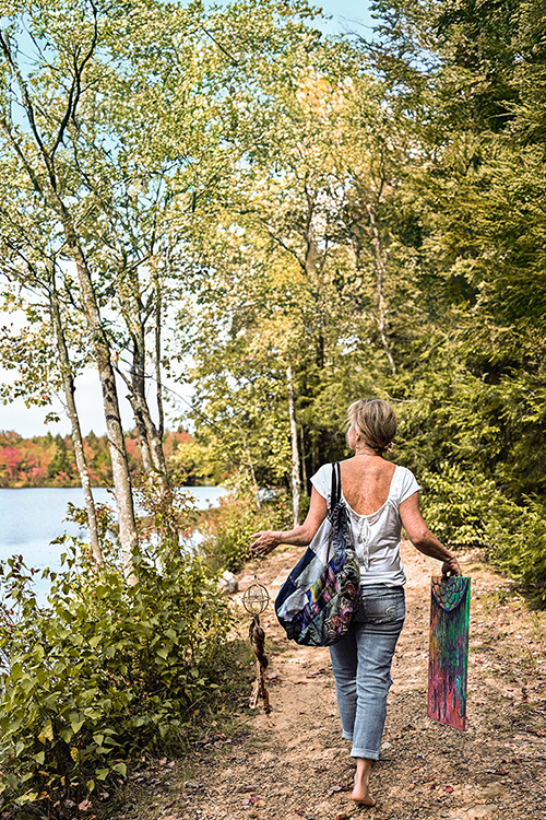 Michelle walking lakeside with Dreamcatcher and painting
