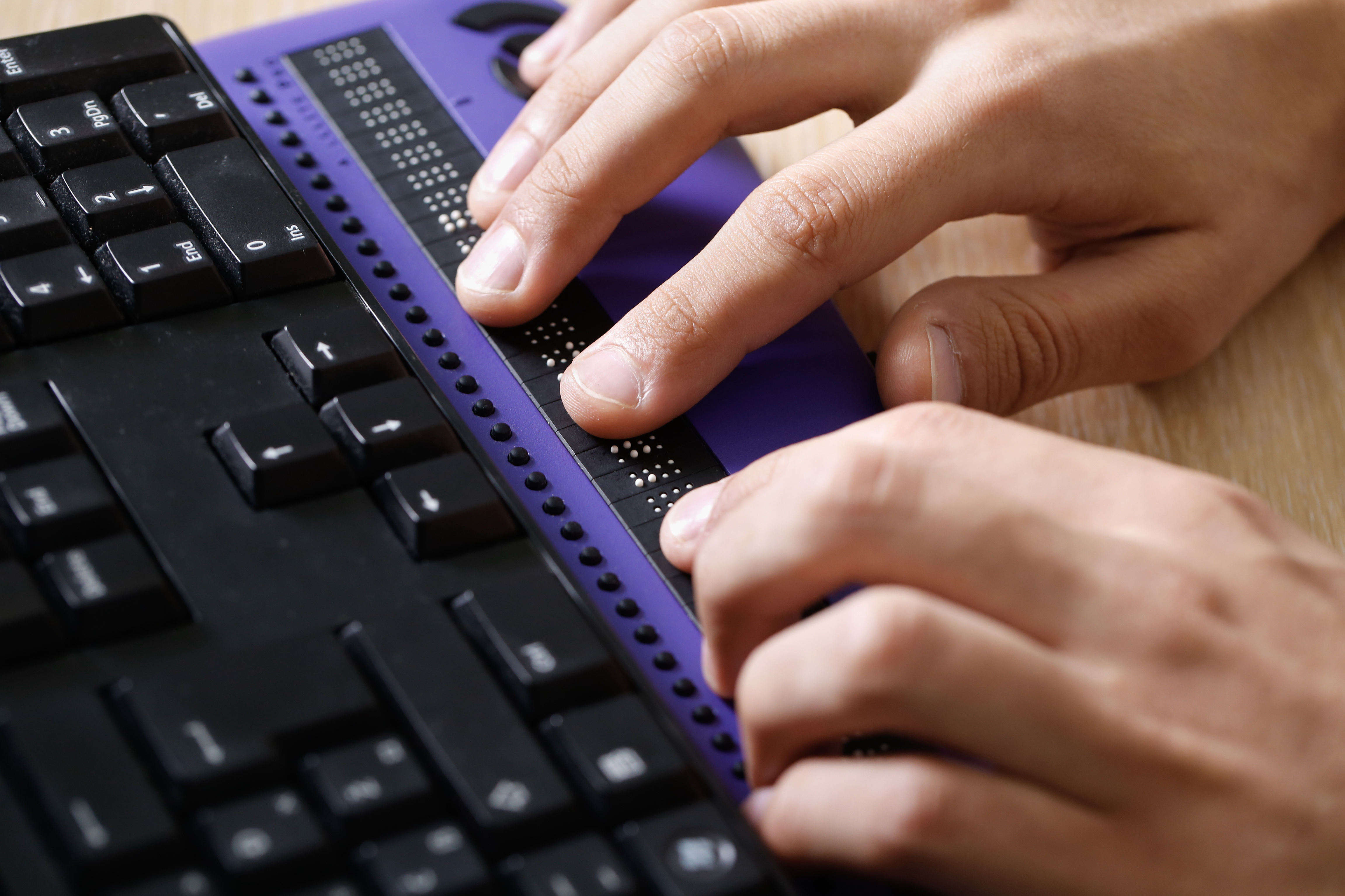 hands on a braille display