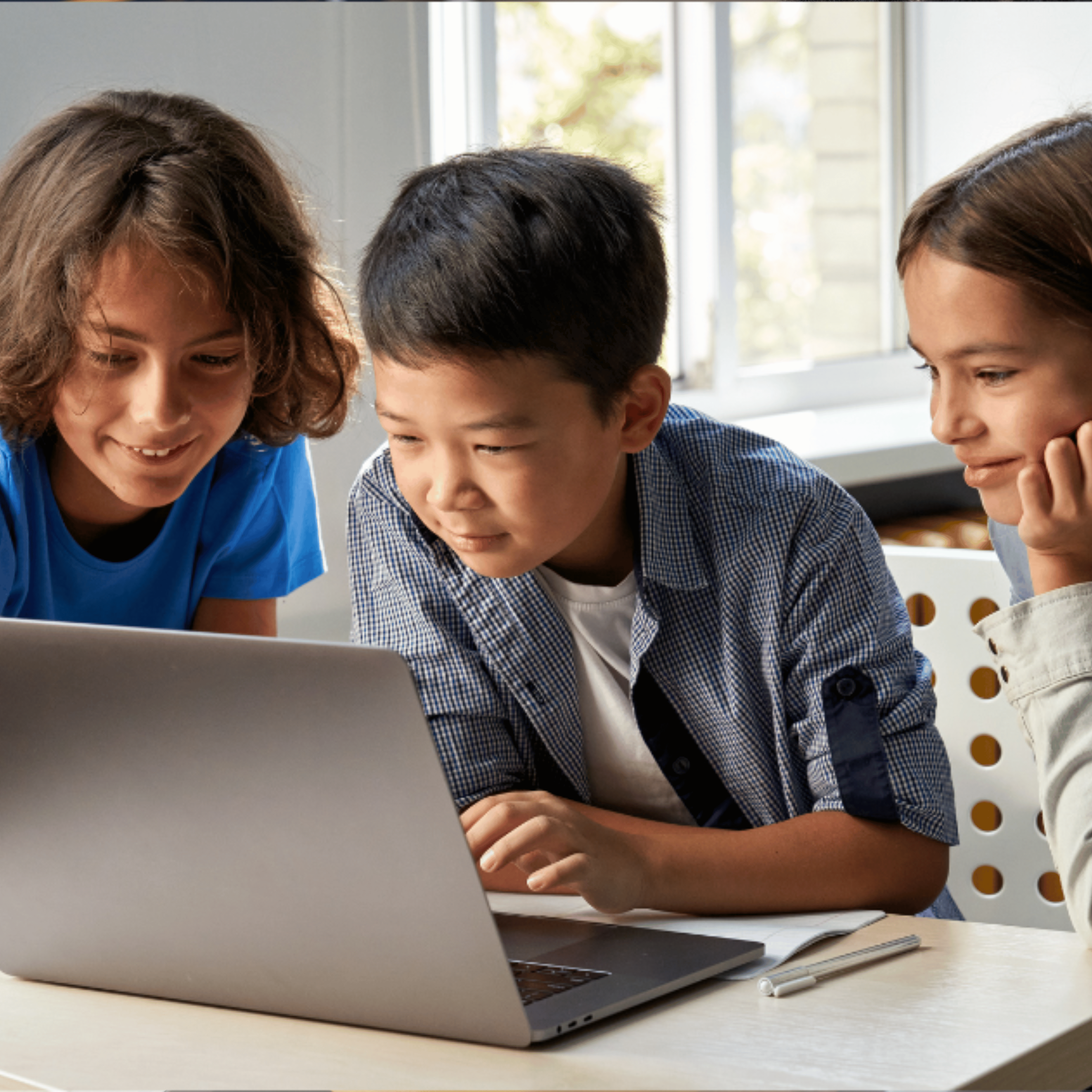 3 students working on a laptop