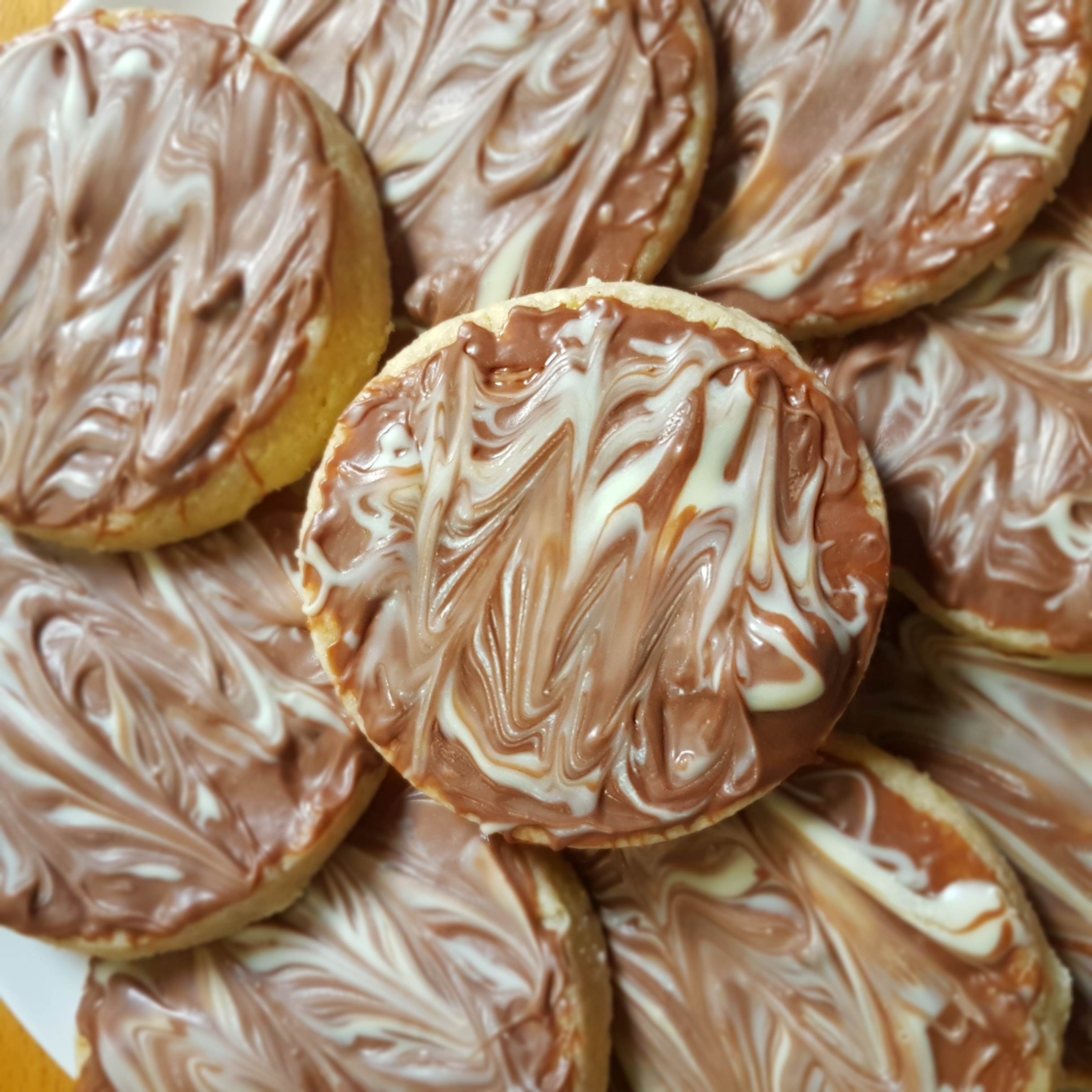 A plat of cookies with melted chocolate on top.