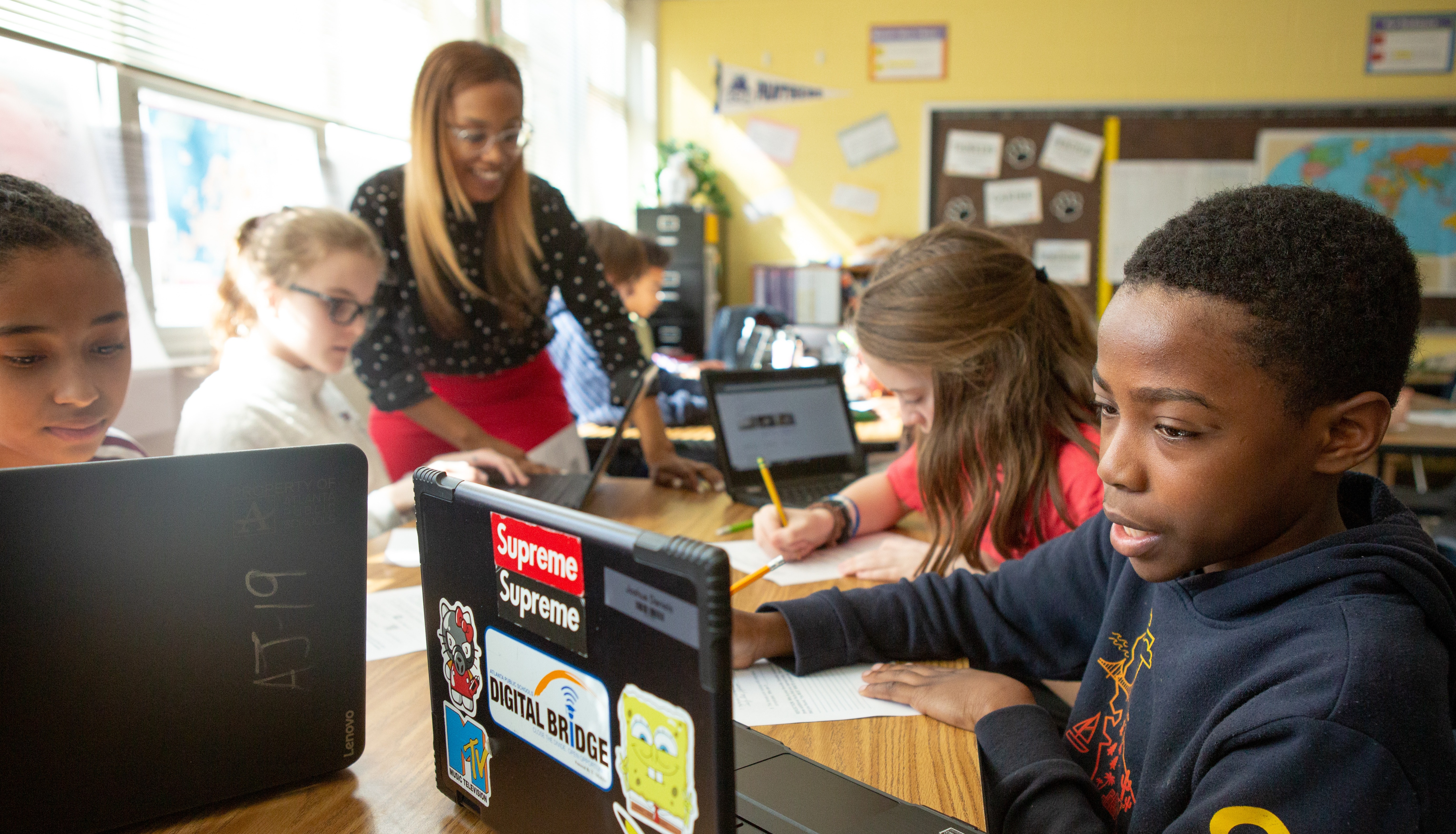 Students at Sutton Middle School use online research to answer questions during a lesson in history class.