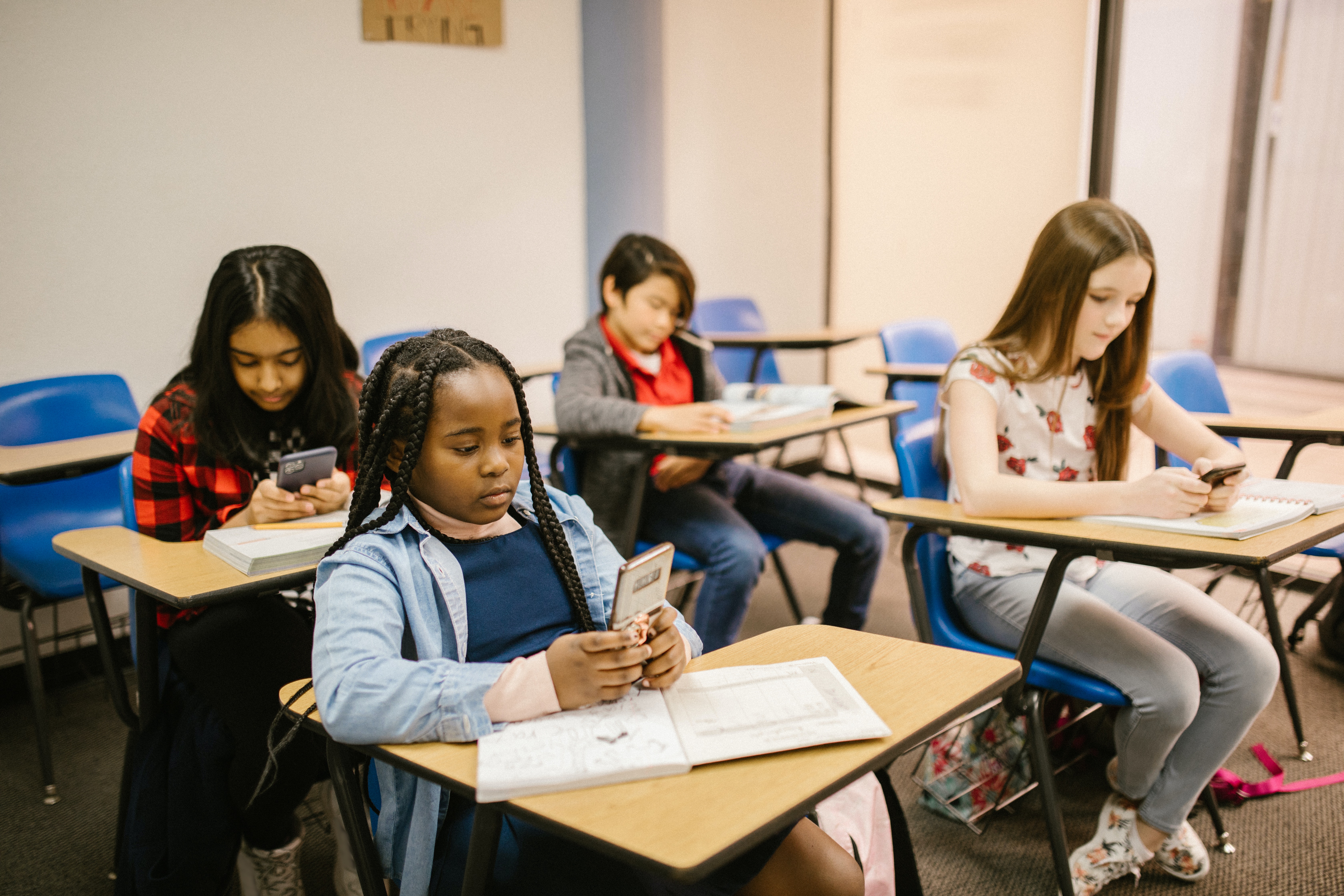 students using phones to interact in class