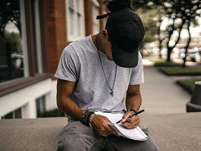 A young man writing in a notebook