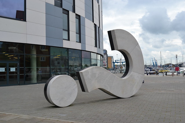 Sculpture of a question mark lying on its back