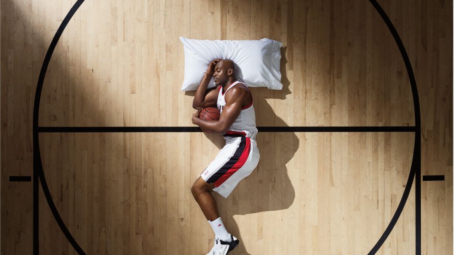 Basketball athlete sleeping on a pillow to facilitate better hamstring and muscle recovery