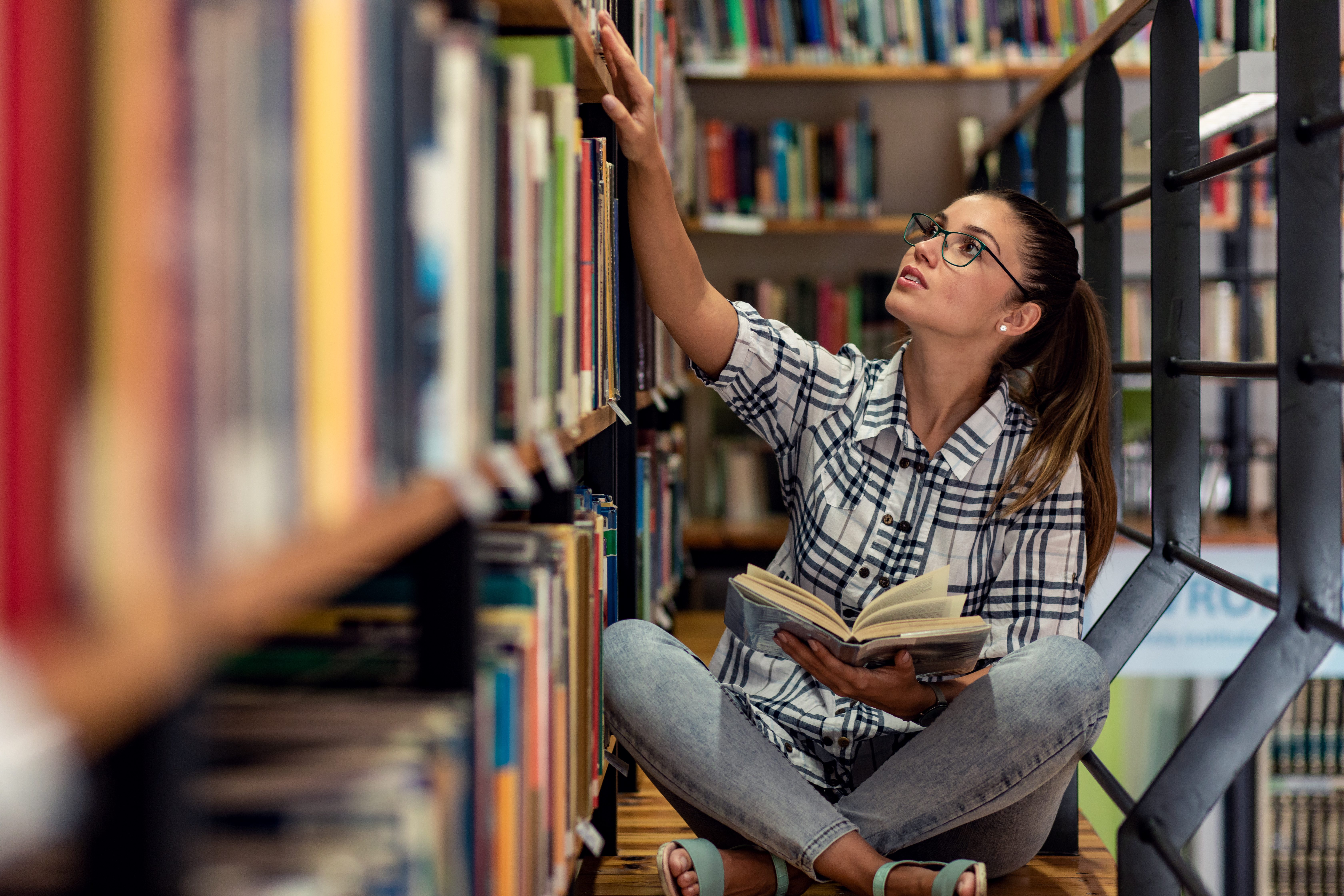 Woman holding a book in the library