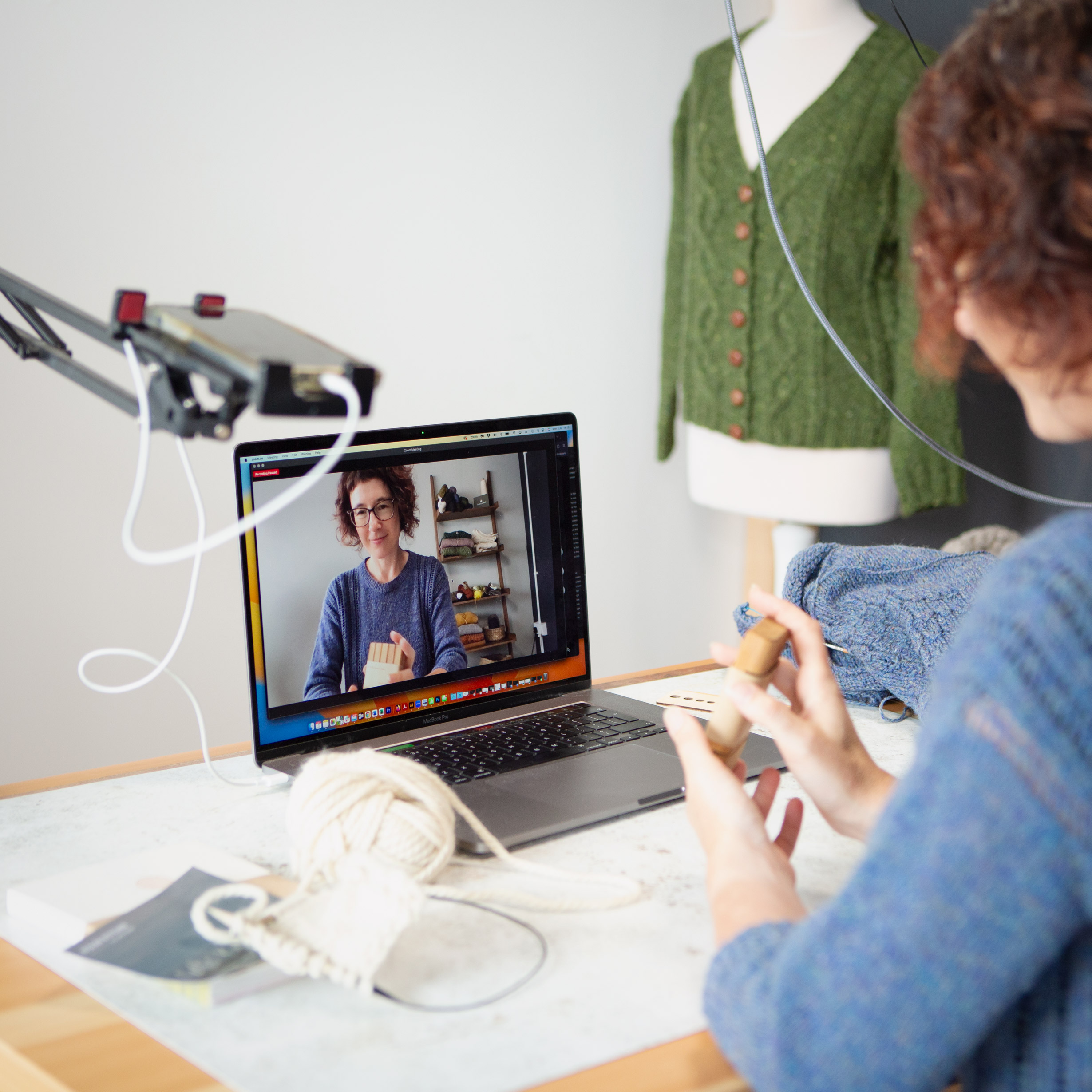 Carol Feller showing knitting to computer screen