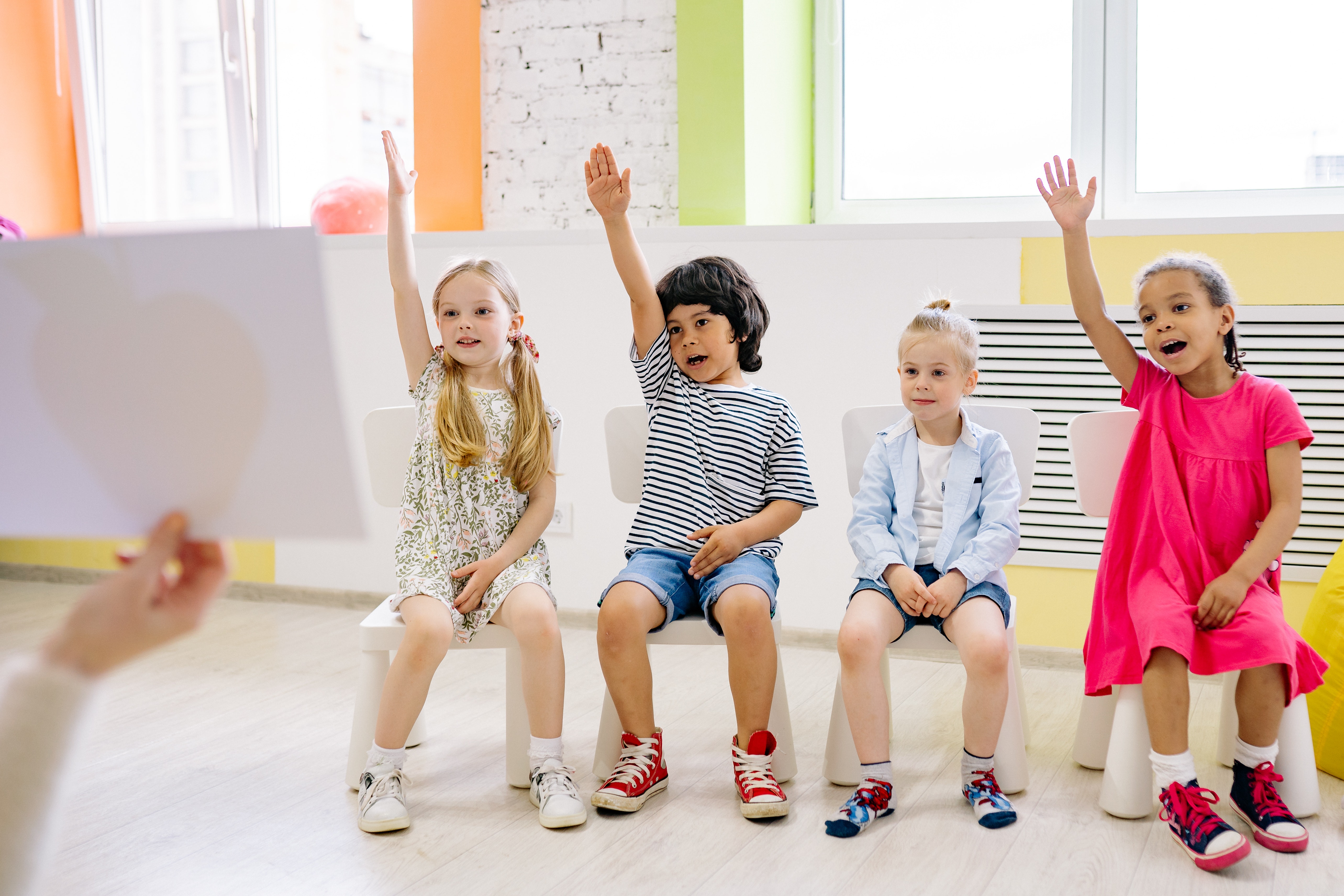 4 students raising their hands