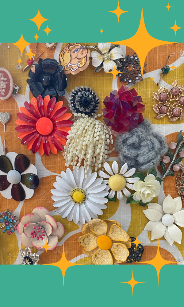 Many colorful vintage brooches