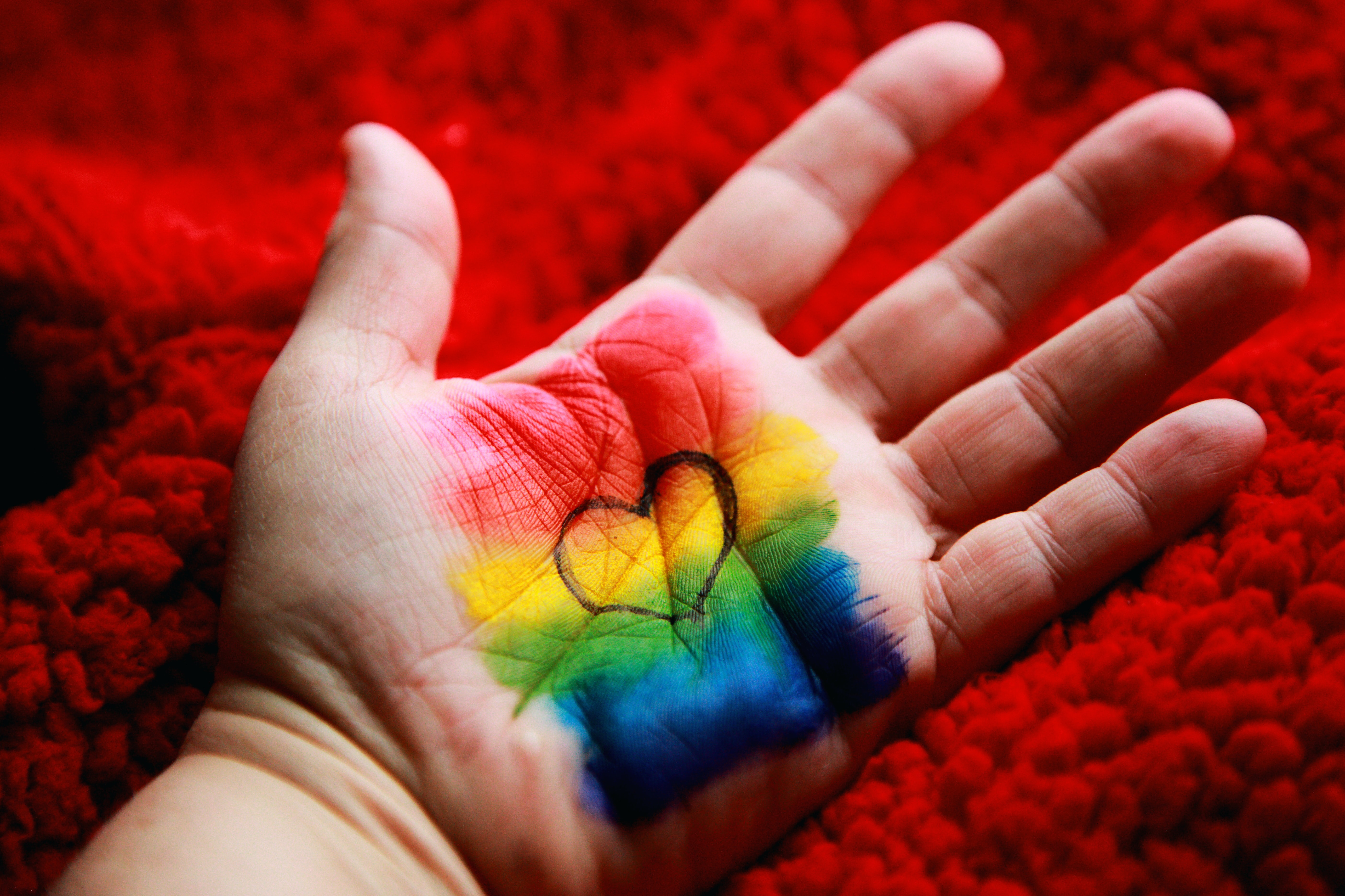 a white person&#39;s handout with a rainbow and a heart drawn on it to represent inclusion
